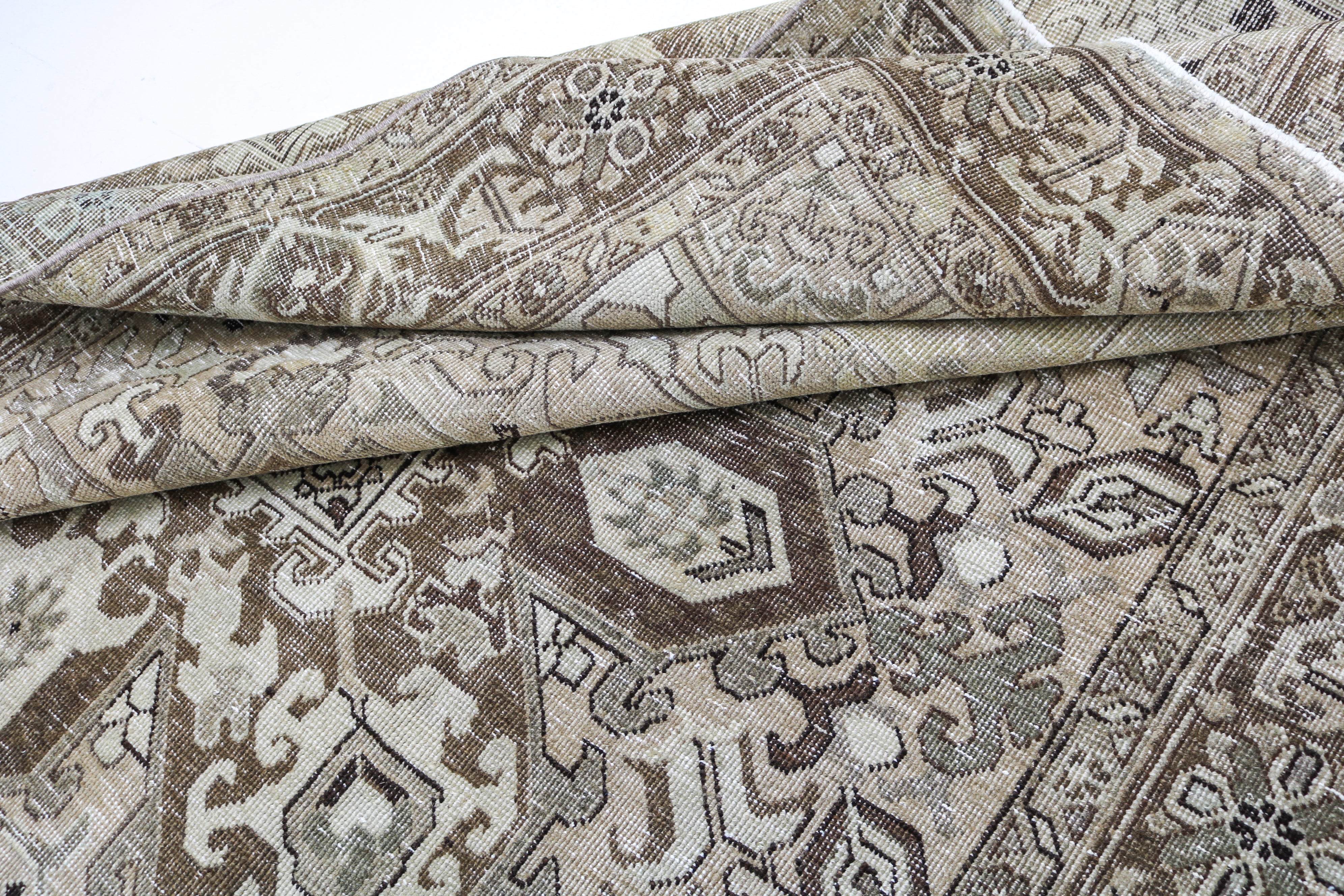 Vintage Persian rug close-up showing fine geometric weaving and subtle natural colour variation