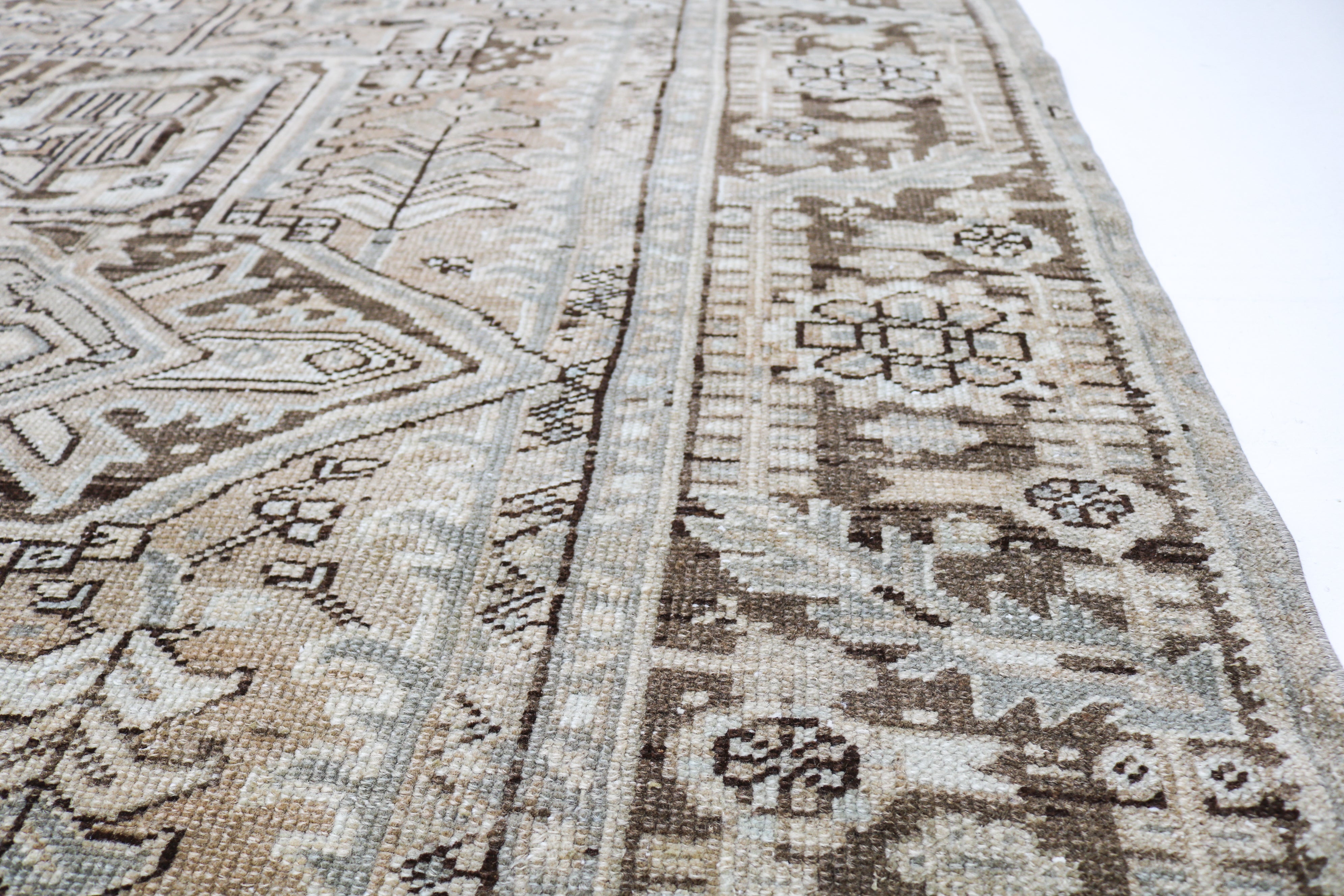 Large antique Persian Heriz carpet with geometric medallion design in ivory and beige tones