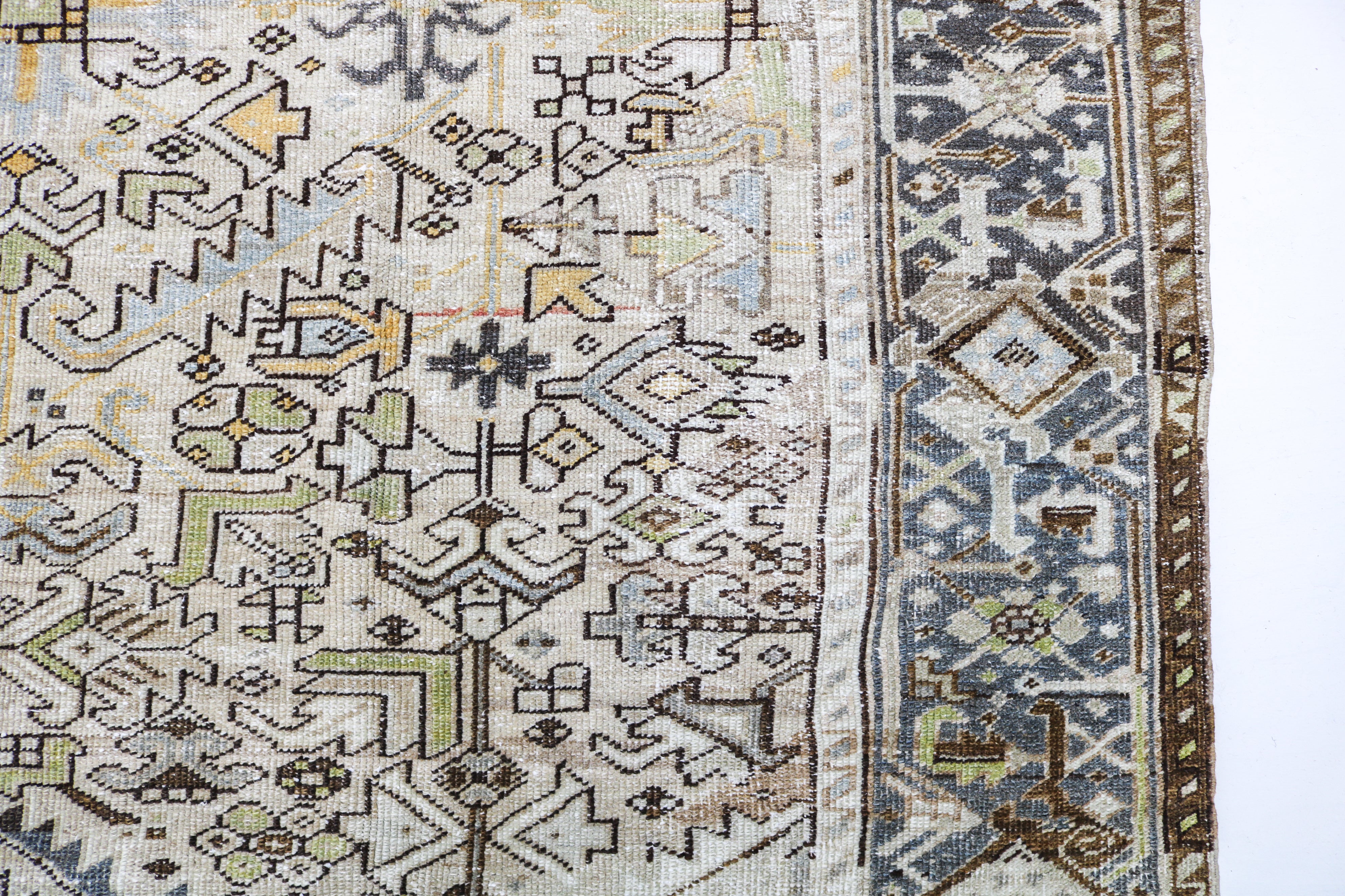 Antique Persian carpet close-up showing fine geometric weaving and subtle natural colour variation