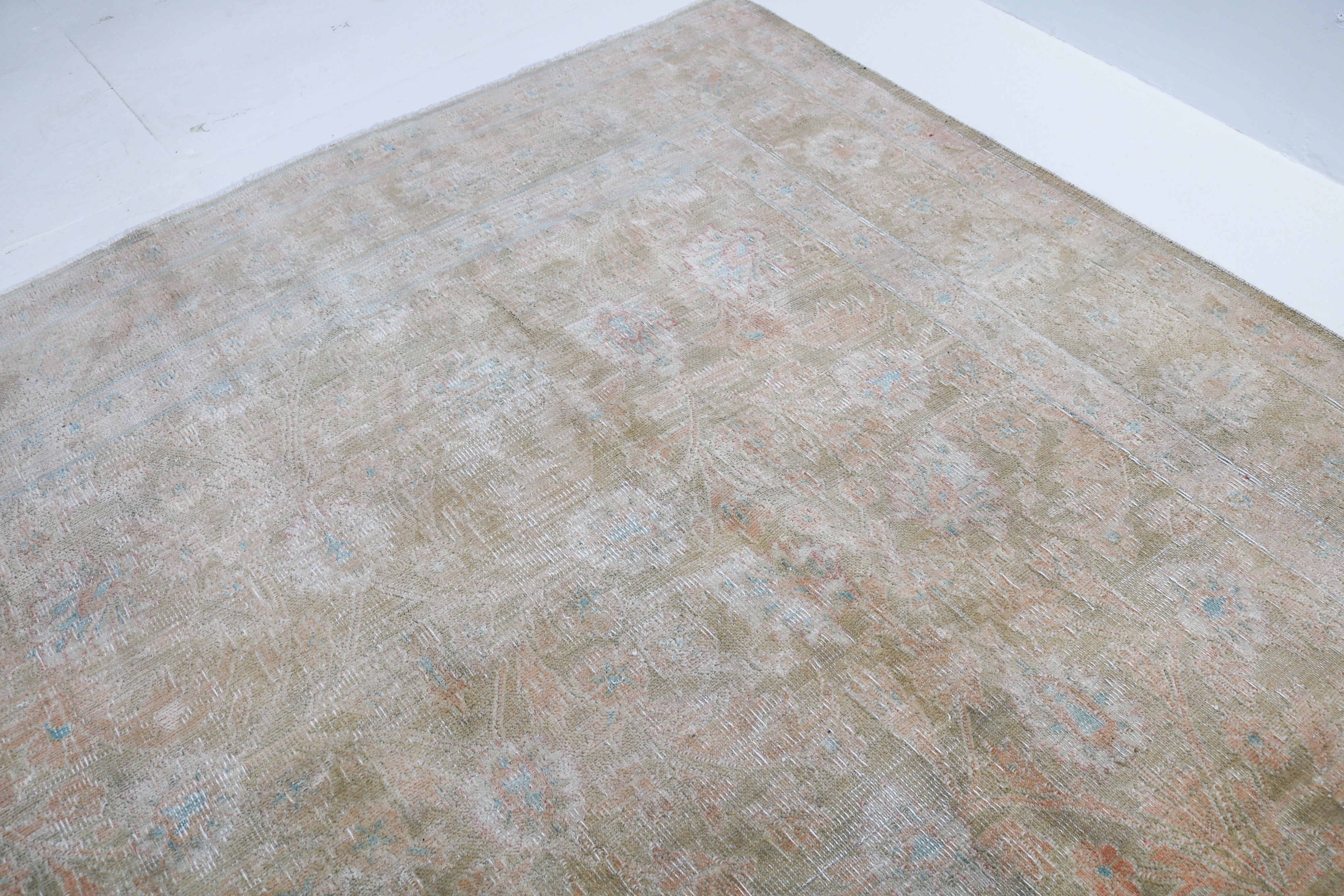 Vintage Sarouk carpet detail featuring refined floral design and subtle blush accents