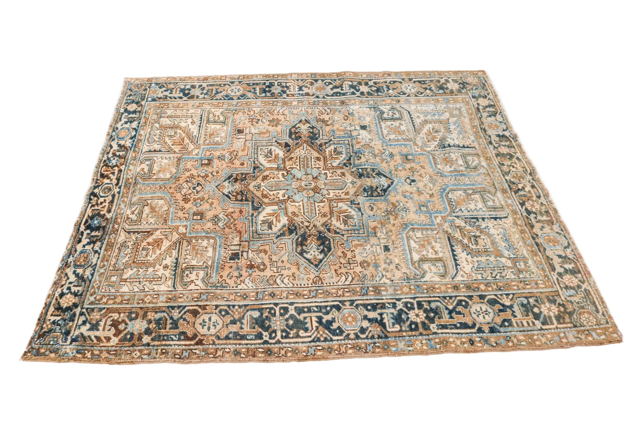 Antique Persian Heriz rug circa 1930 displayed with traditional geometric medallion pattern