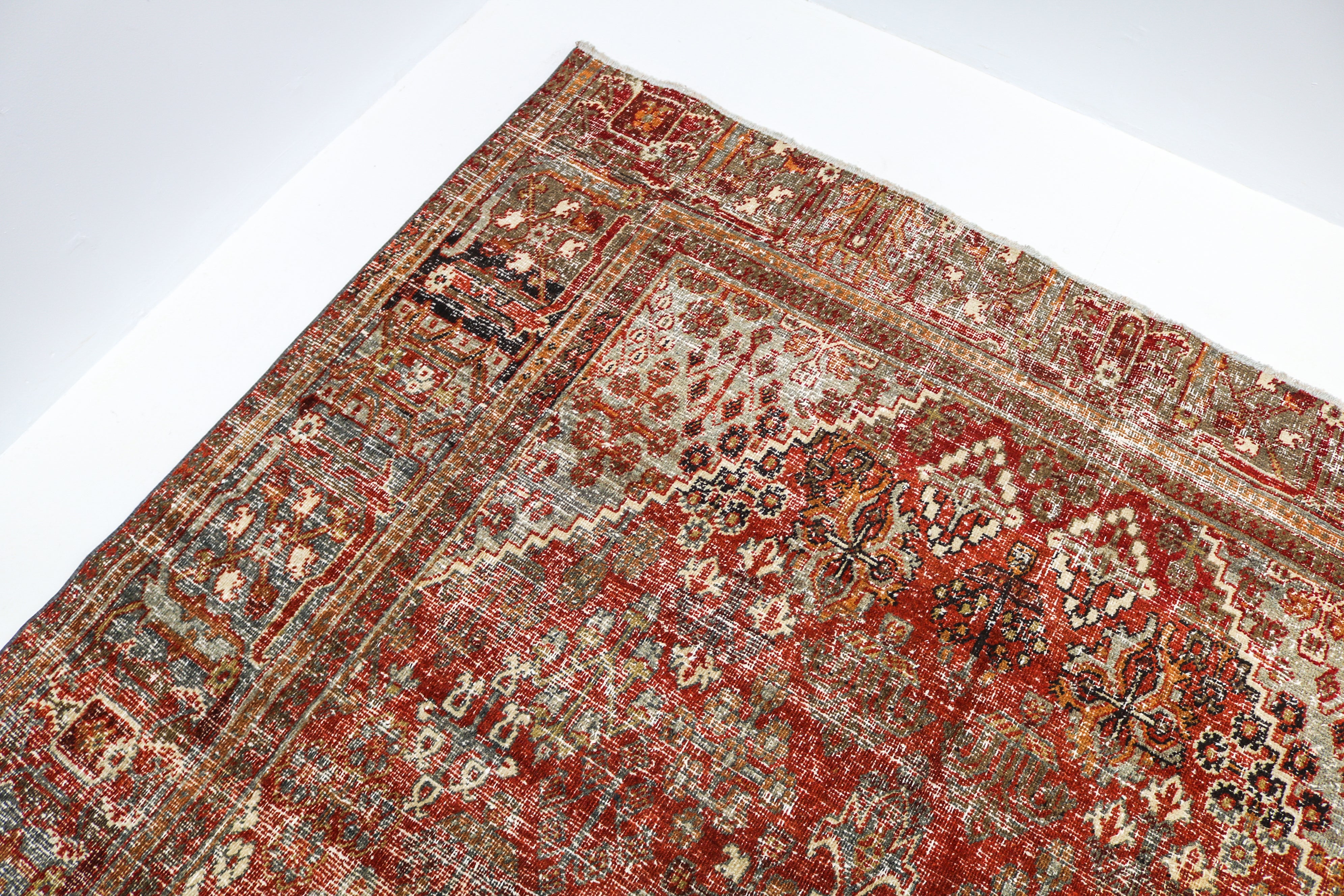 Hand-knotted antique Persian Josheqan rug with intricate geometric motifs and naturally aged colours