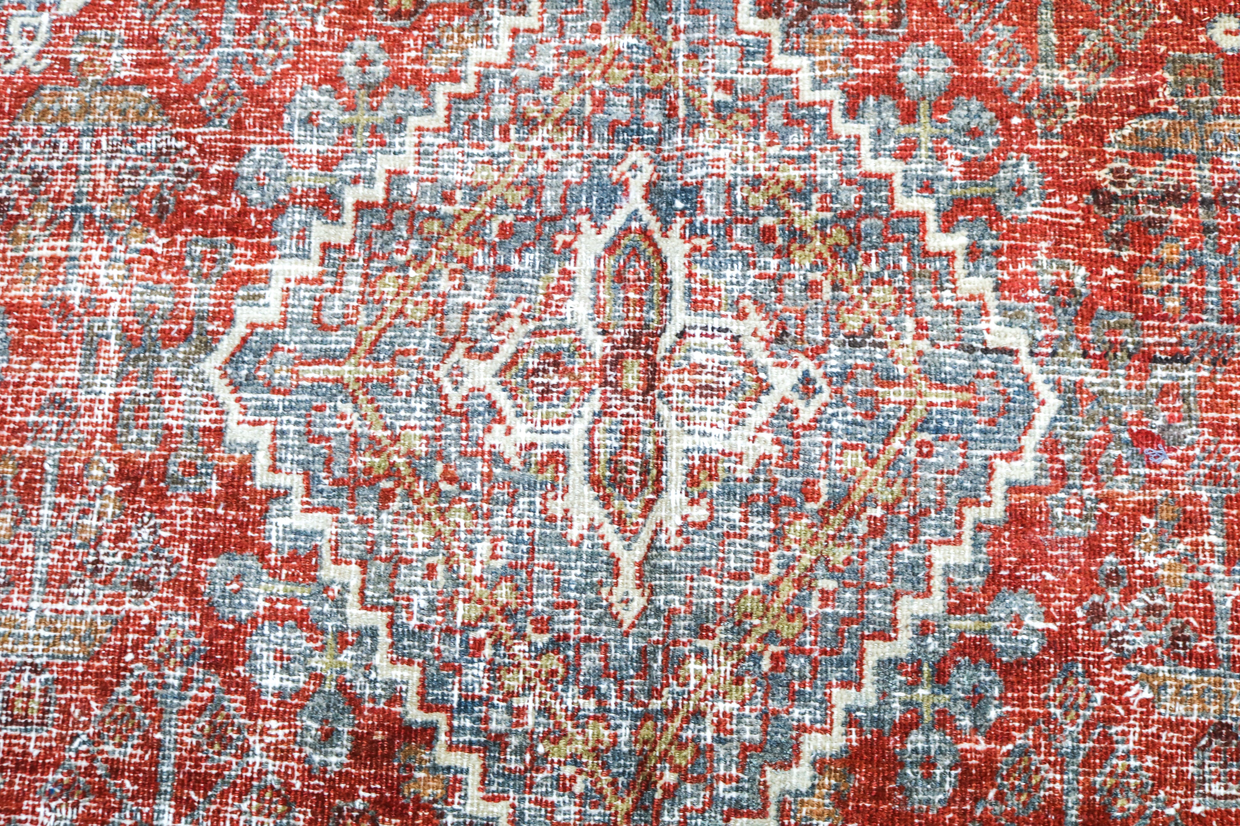 Close-up detail of antique Persian Josheqan rug showing handwoven floral motifs and aged wool colours