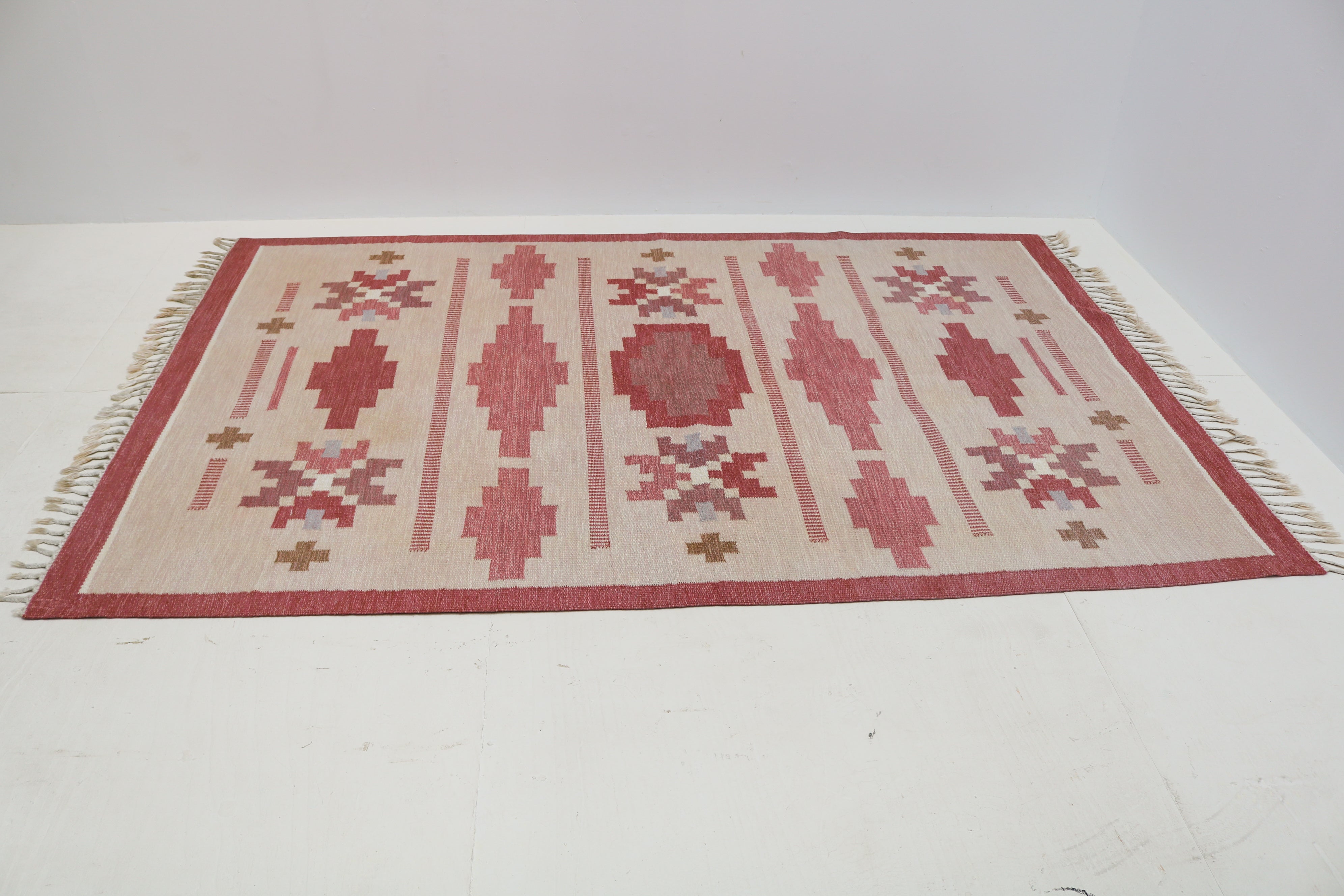 Close-up of vintage Swedish kilim with dusty pink, ivory, taupe and pale blue geometric motifs
