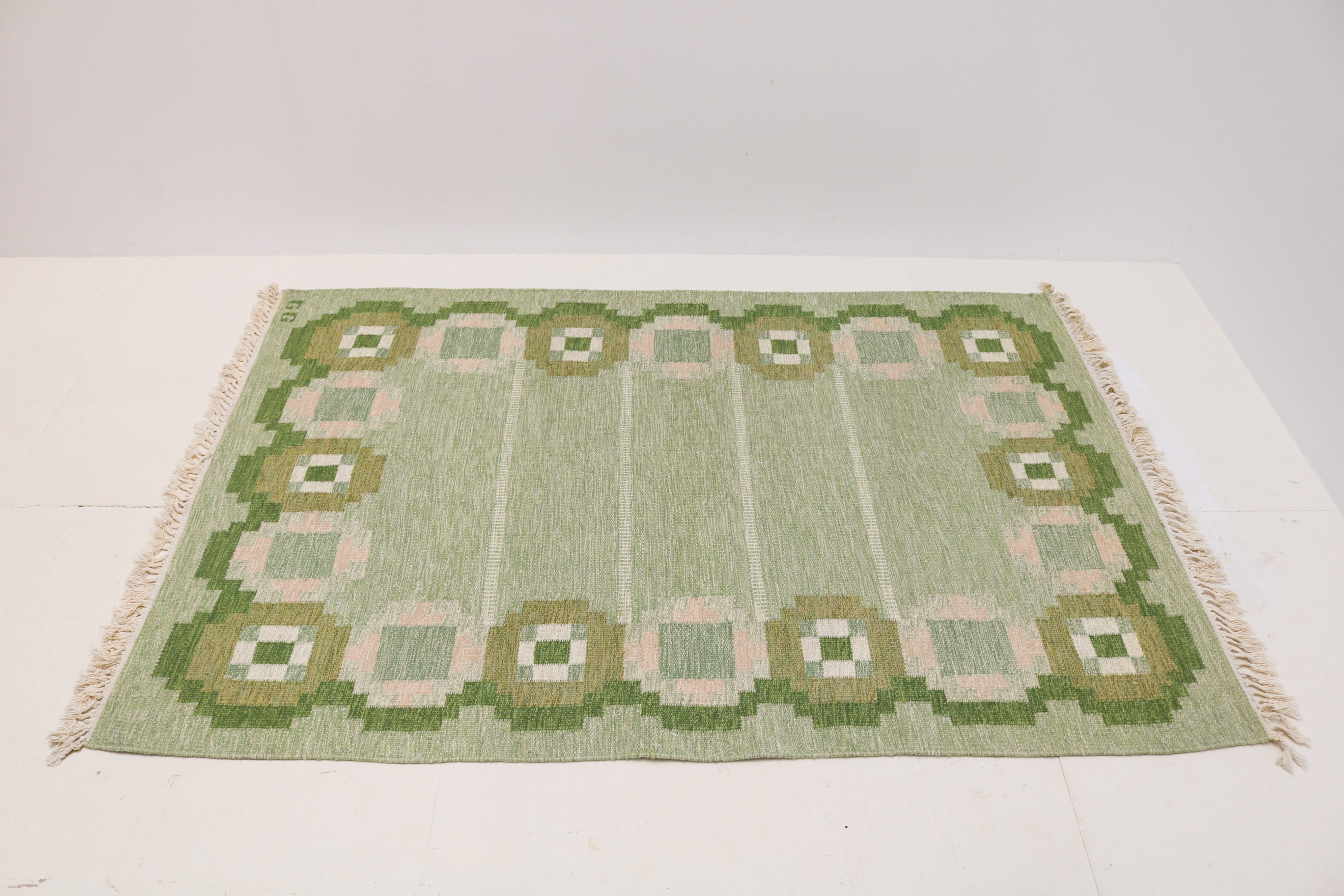 Handwoven Swedish flatweave rug with green geometric border