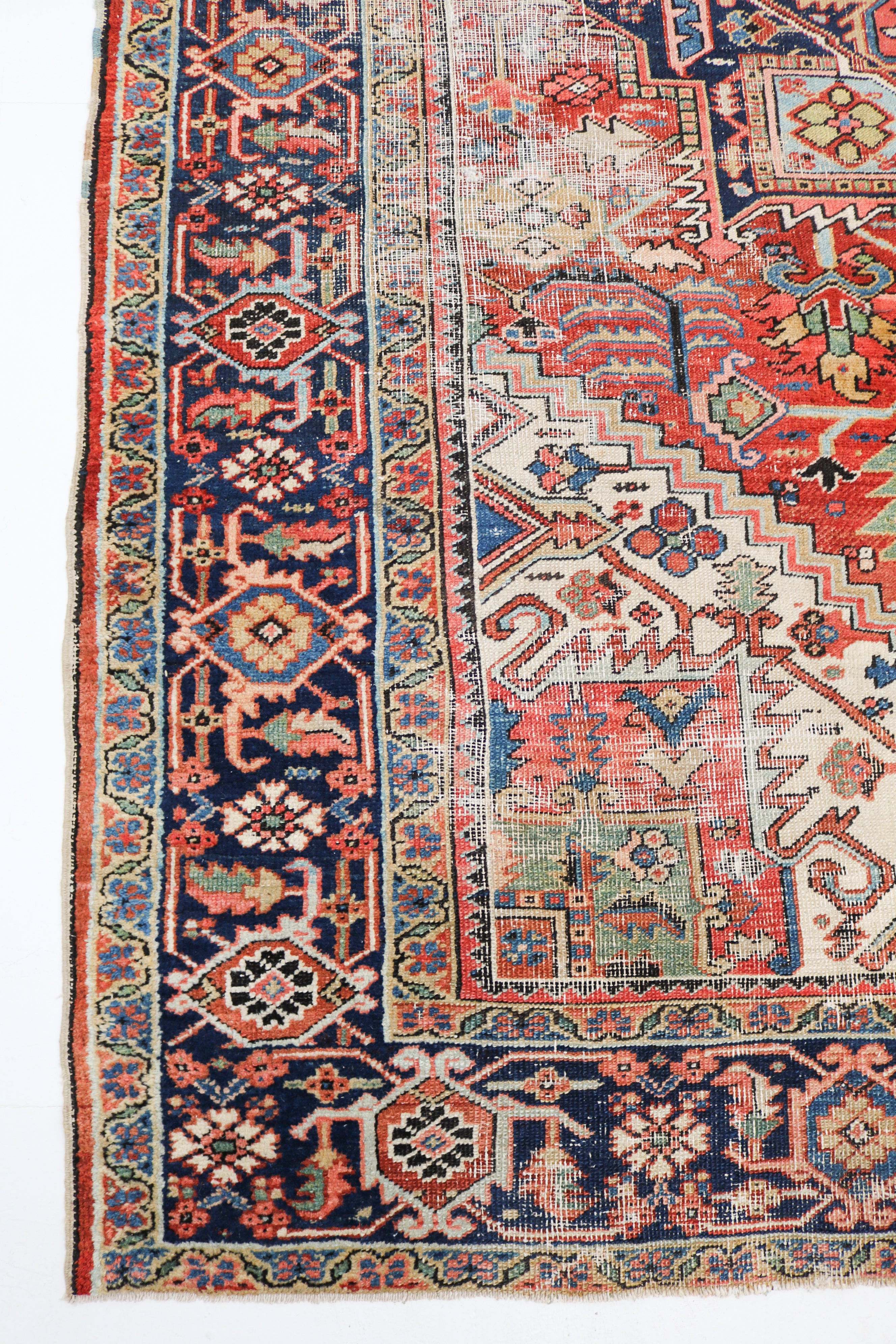 Antique Persian Heriz rug circa 1910, 335 × 266 cm, with terracotta geometric medallion and navy border