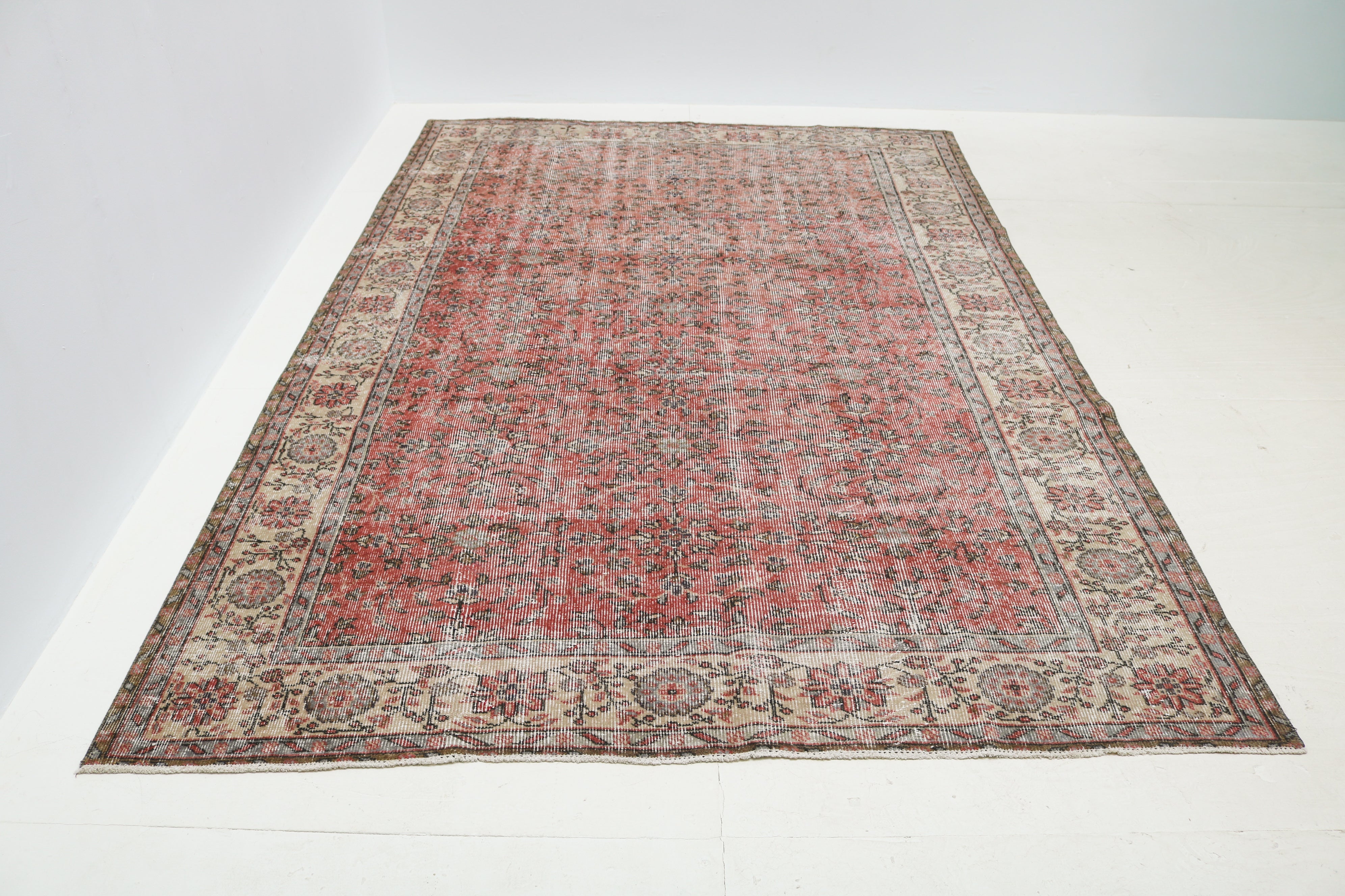 Hand-knotted vintage Turkish rug detail showing floral motifs and beautifully aged low pile