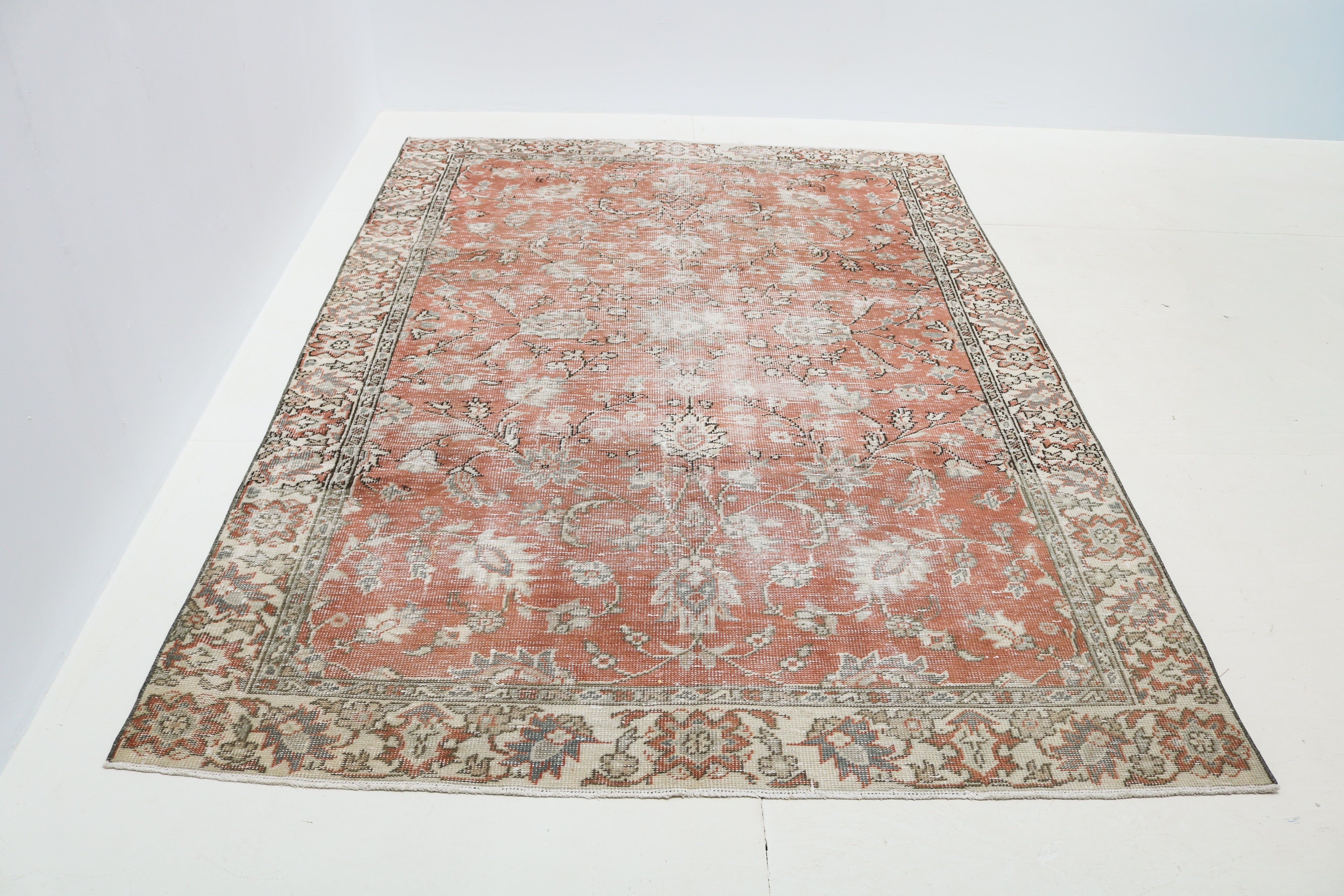 Hand-knotted vintage Turkish rug in faded terracotta, ivory, grey and muted blue tones