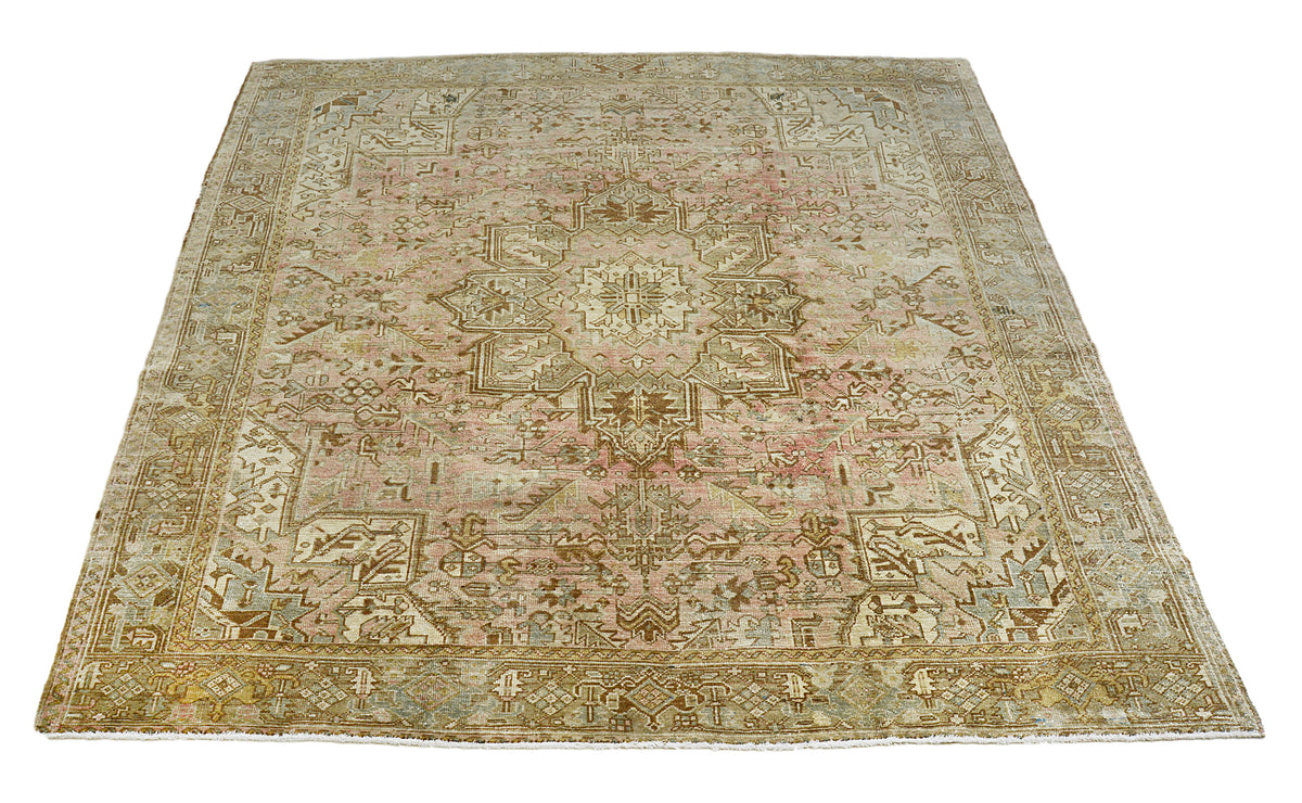 Full view of vintage Persian Heriz carpet with central medallion and structured border