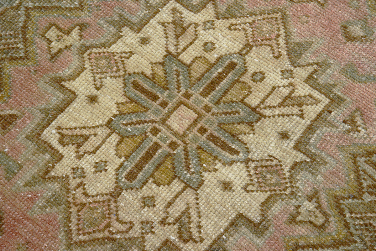 Close-up of Persian Heriz carpet with angular motifs and naturally aged colours