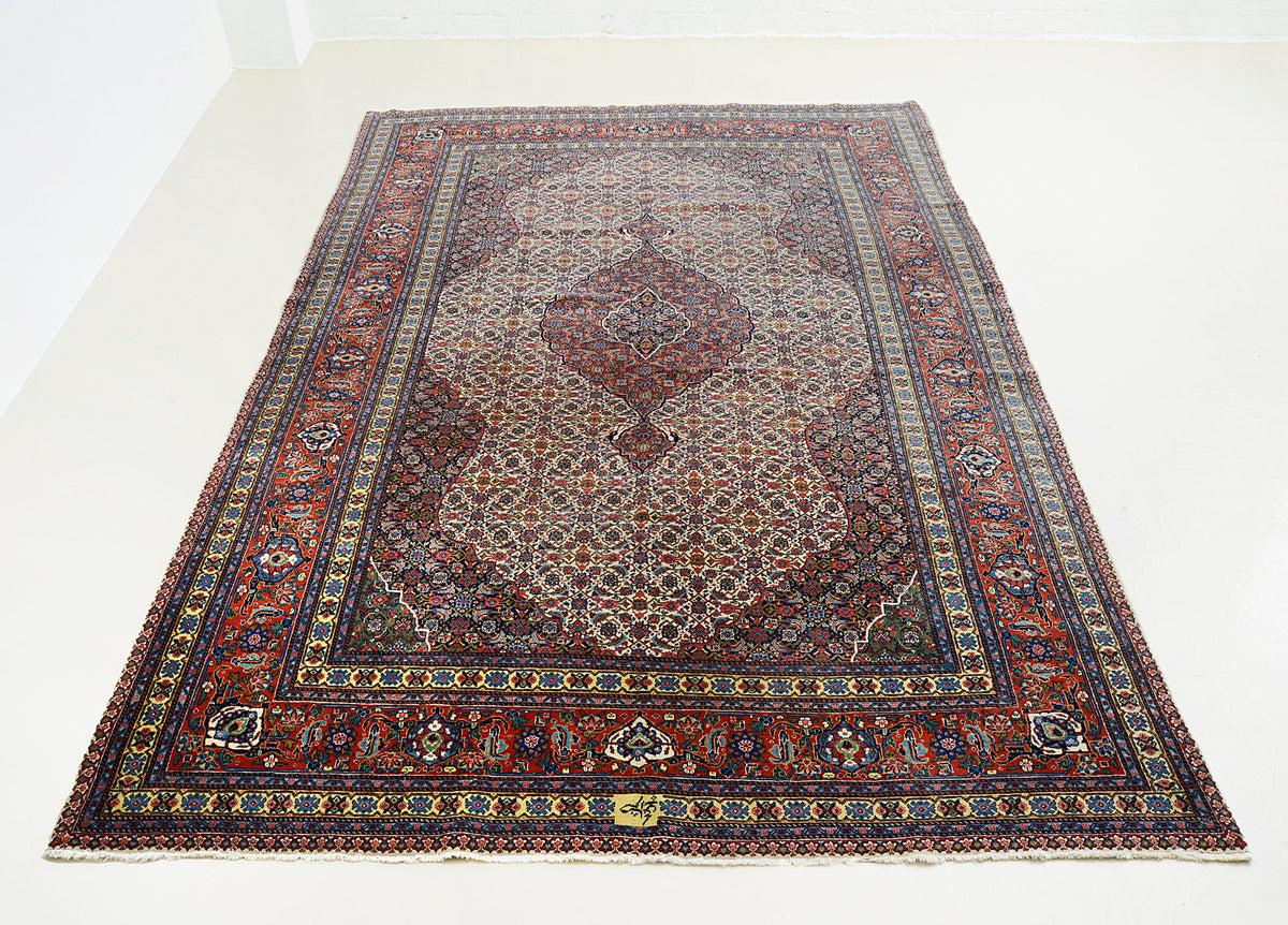 Full view of vintage Persian Tabriz carpet with all-over pattern and central emphasis