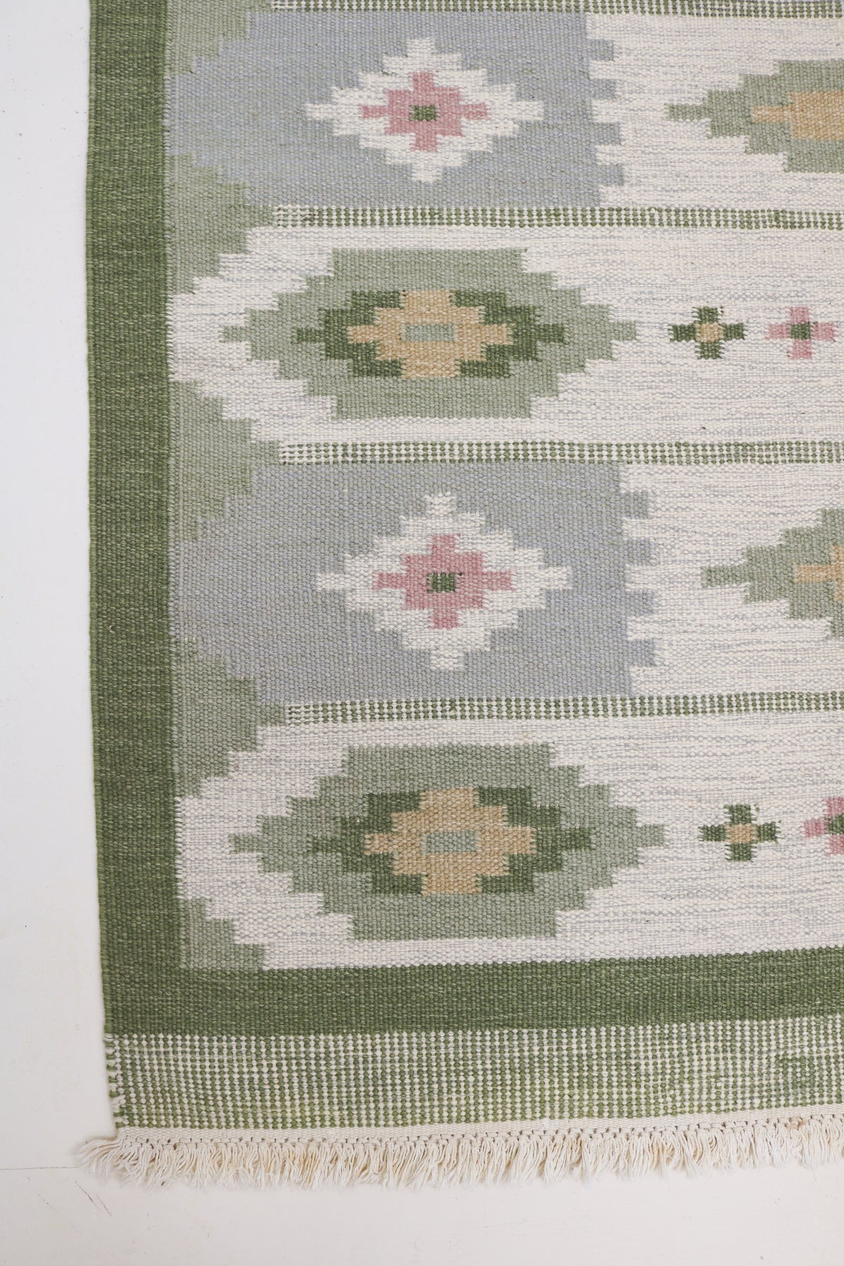 Vintage Swedish Kilim rug with pale grey field, geometric motifs and deep green border