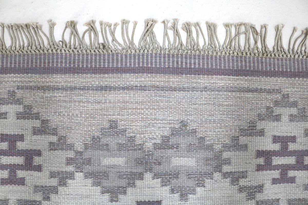 Close-up of Kilim field with layered geometric motifs in grey and cream