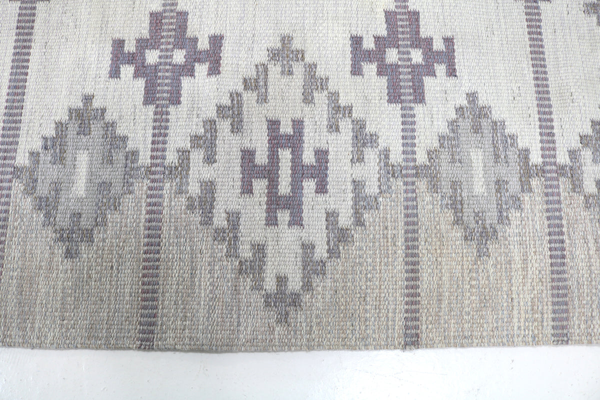 Close-up showing symmetrical geometric motifs and subtle horizontal woven lines