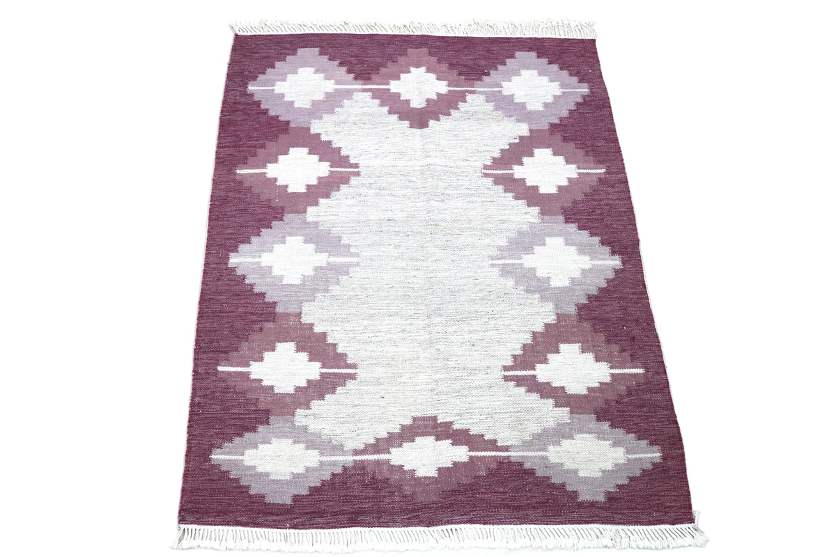Full view of vintage Swedish Kilim rug with repeating geometric design in burgundy and ivory