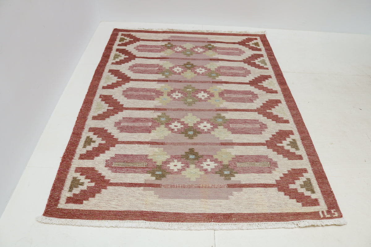 Full view of vintage Swedish Kilim rug with repeating geometric patterns and muted colours