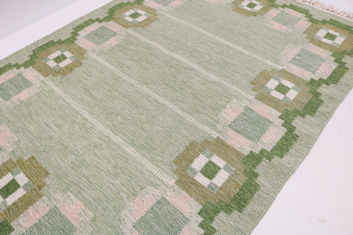 Detailed Swedish Kilim rug with repeating geometric border and subtle woven texture