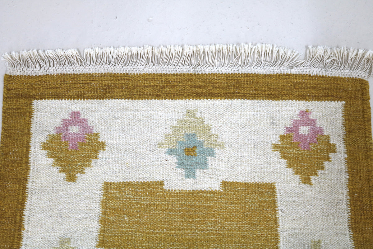 Vintage Swedish Kilim runner with fringed edge and golden ochre geometric patterns