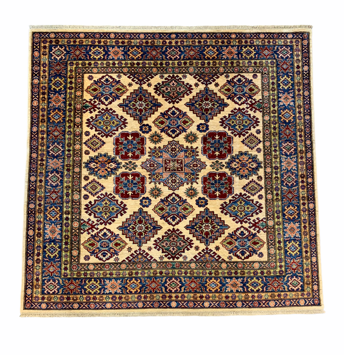 Full view of Afghan Kazak rug showing repeated geometric medallions and bold colours