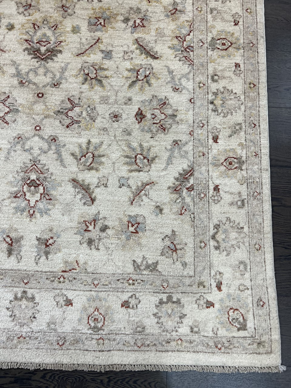 Full rug view showing refined all-over floral composition on an ivory background