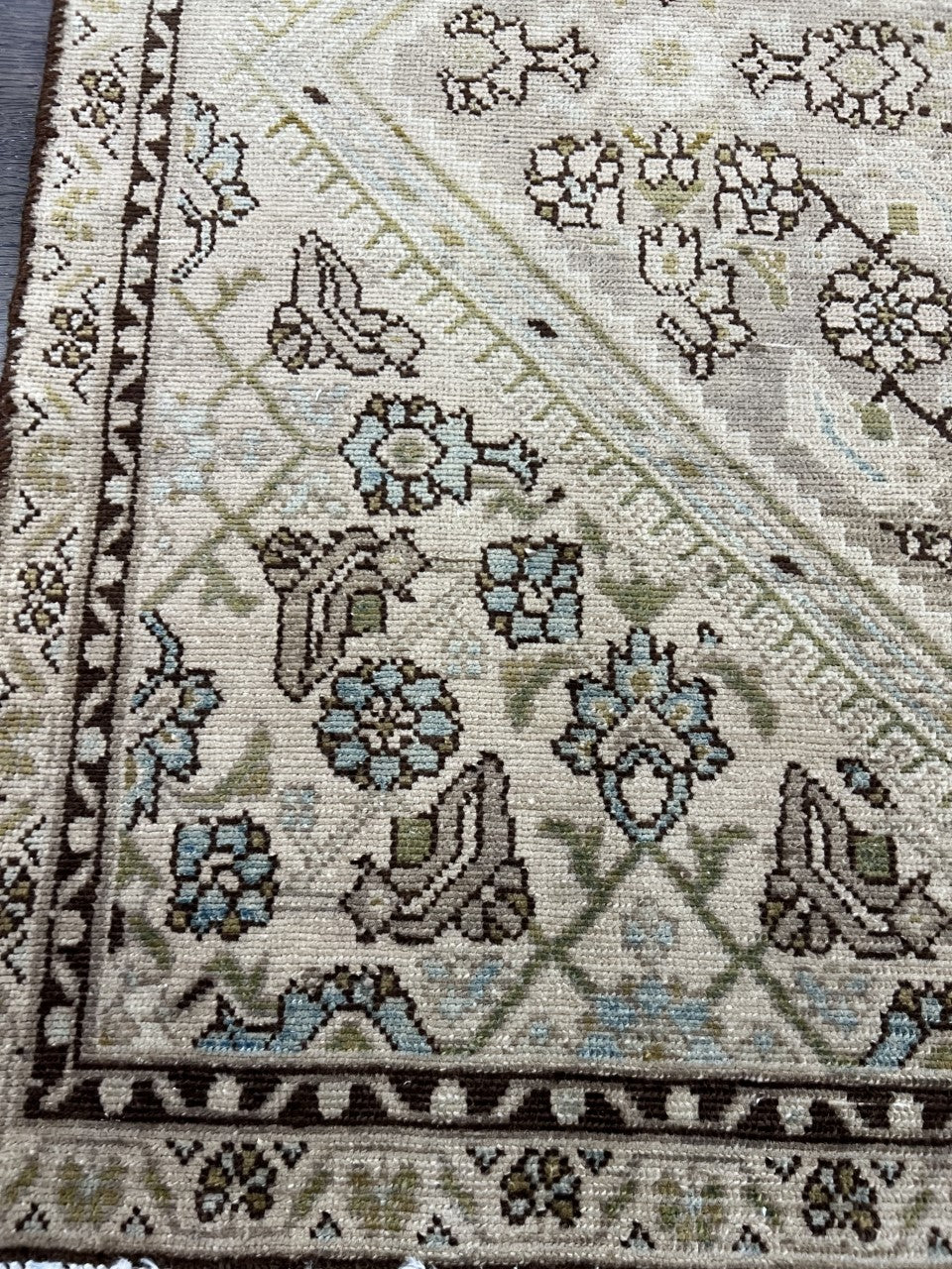 Detailed corner featuring floral designs, diagonal framing and patterned border
