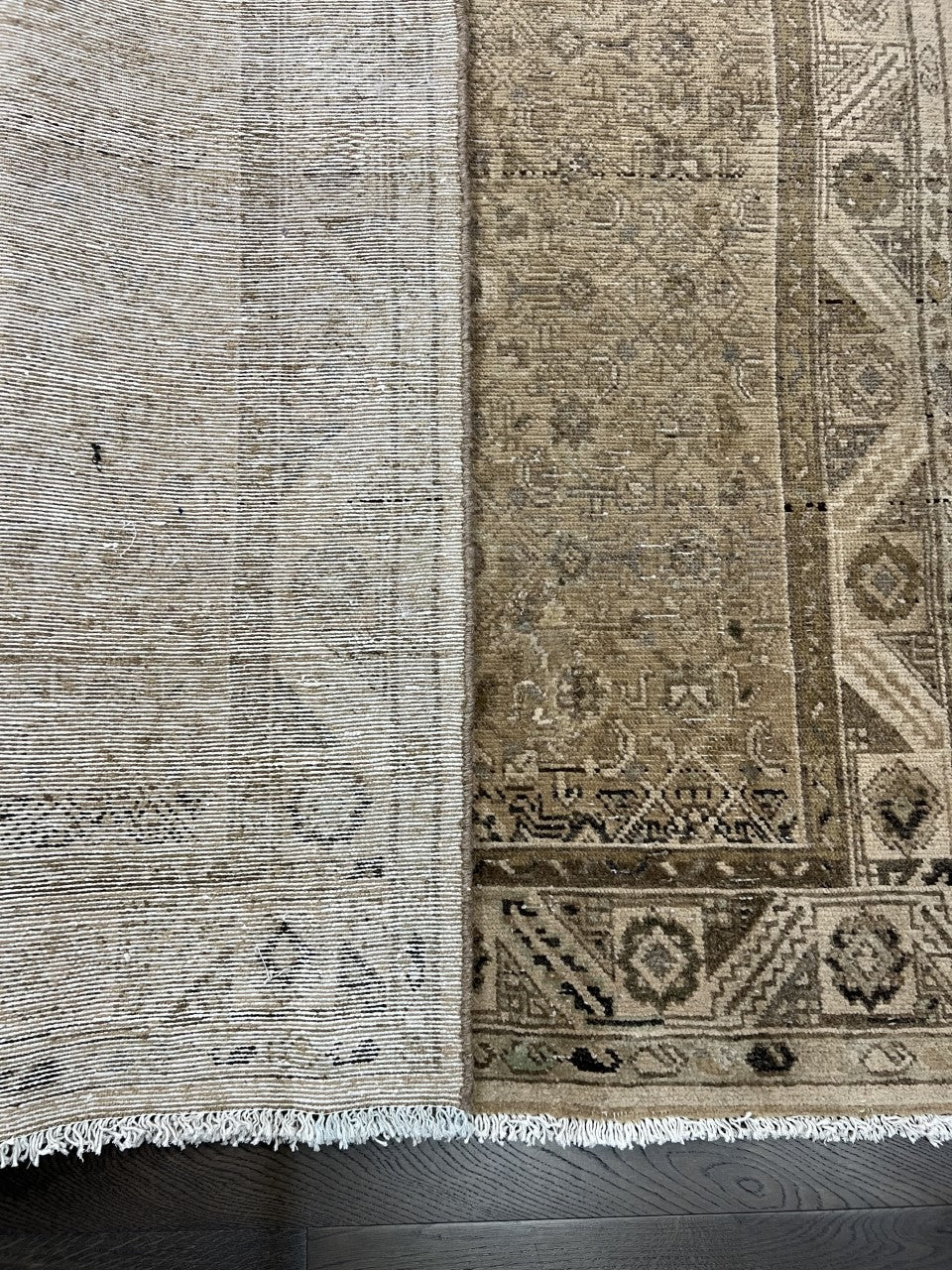 Folded Malayer rug showing patterned reverse and detailed woven texture
