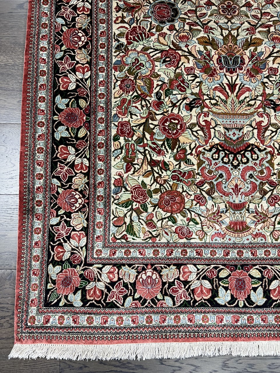 Vintage Persian Qom silk rug with floral niche design and richly patterned red border