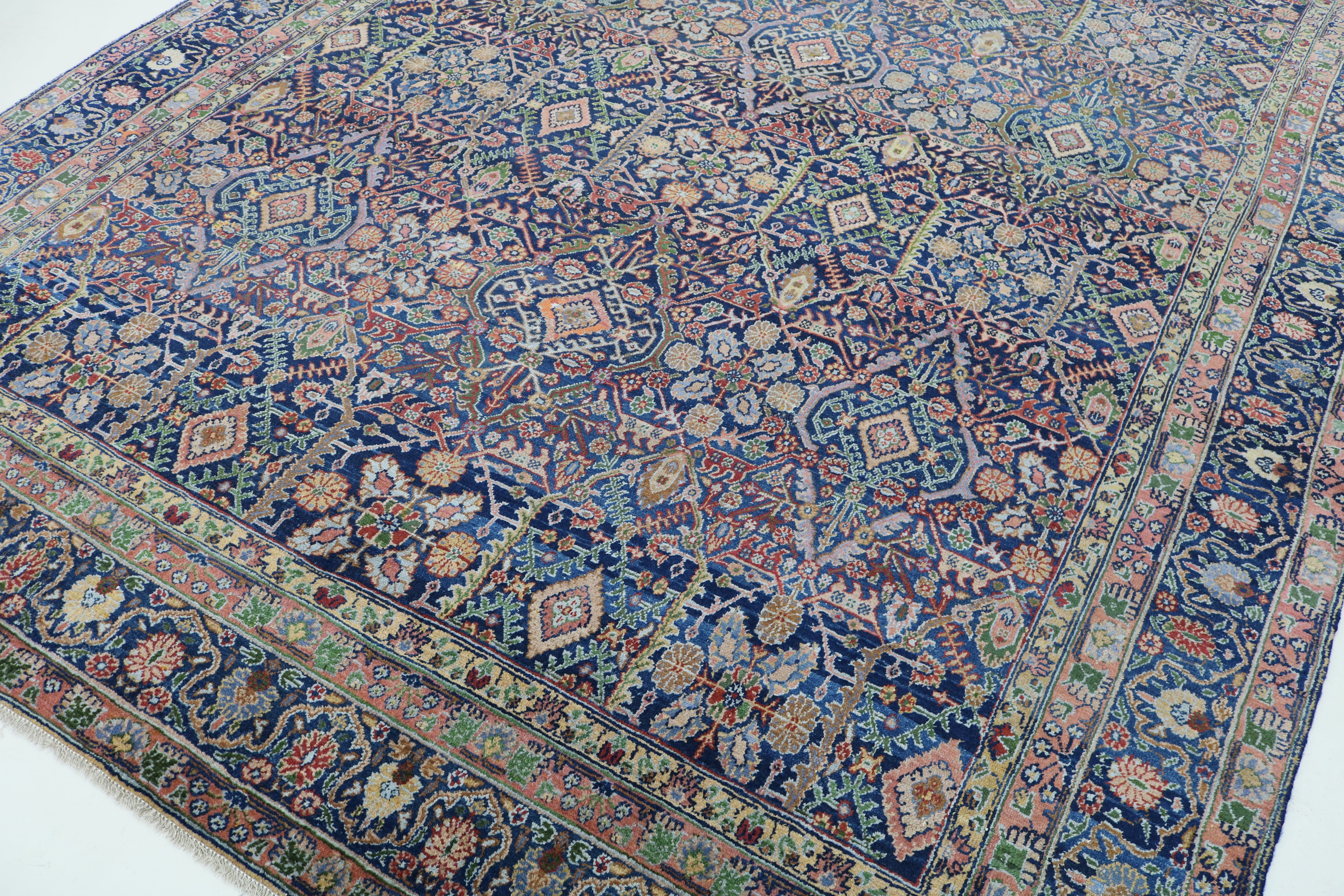 Close-up of finely woven wool texture on antique Persian Senneh carpet
