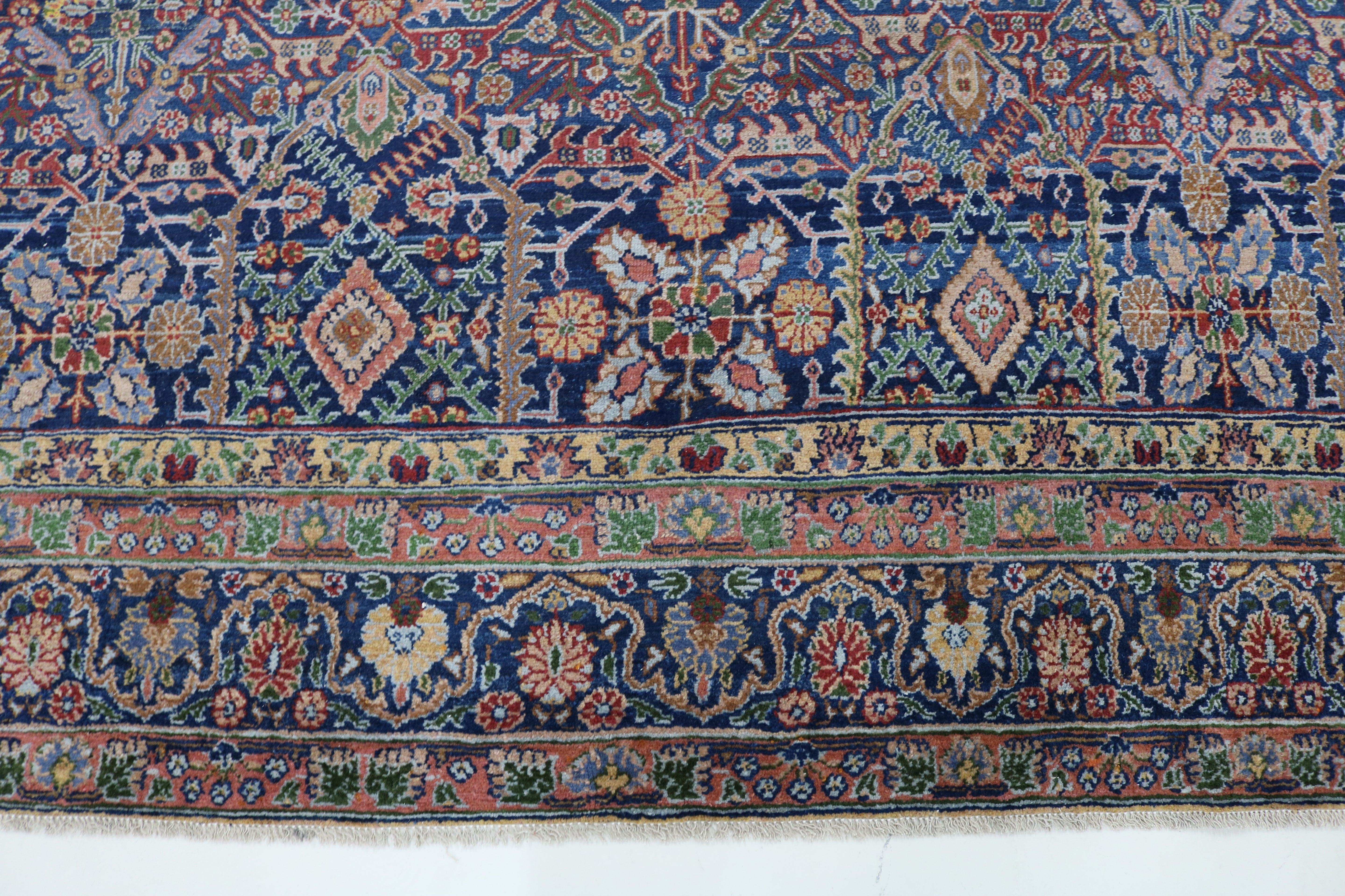 Close-up of finely woven wool texture on antique Persian Senneh carpet
