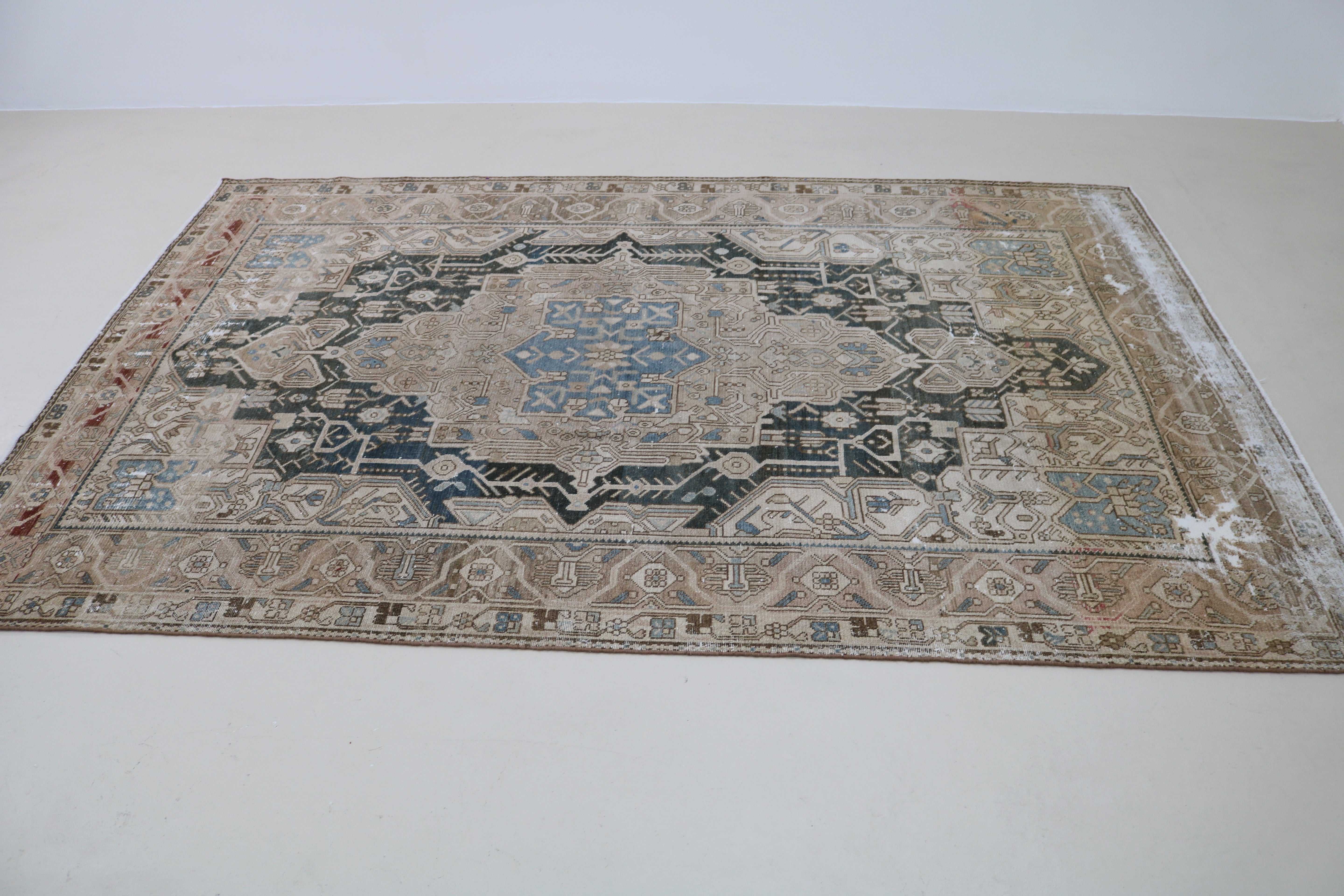 Perspective view of antique Persian Karaja carpet on floor
