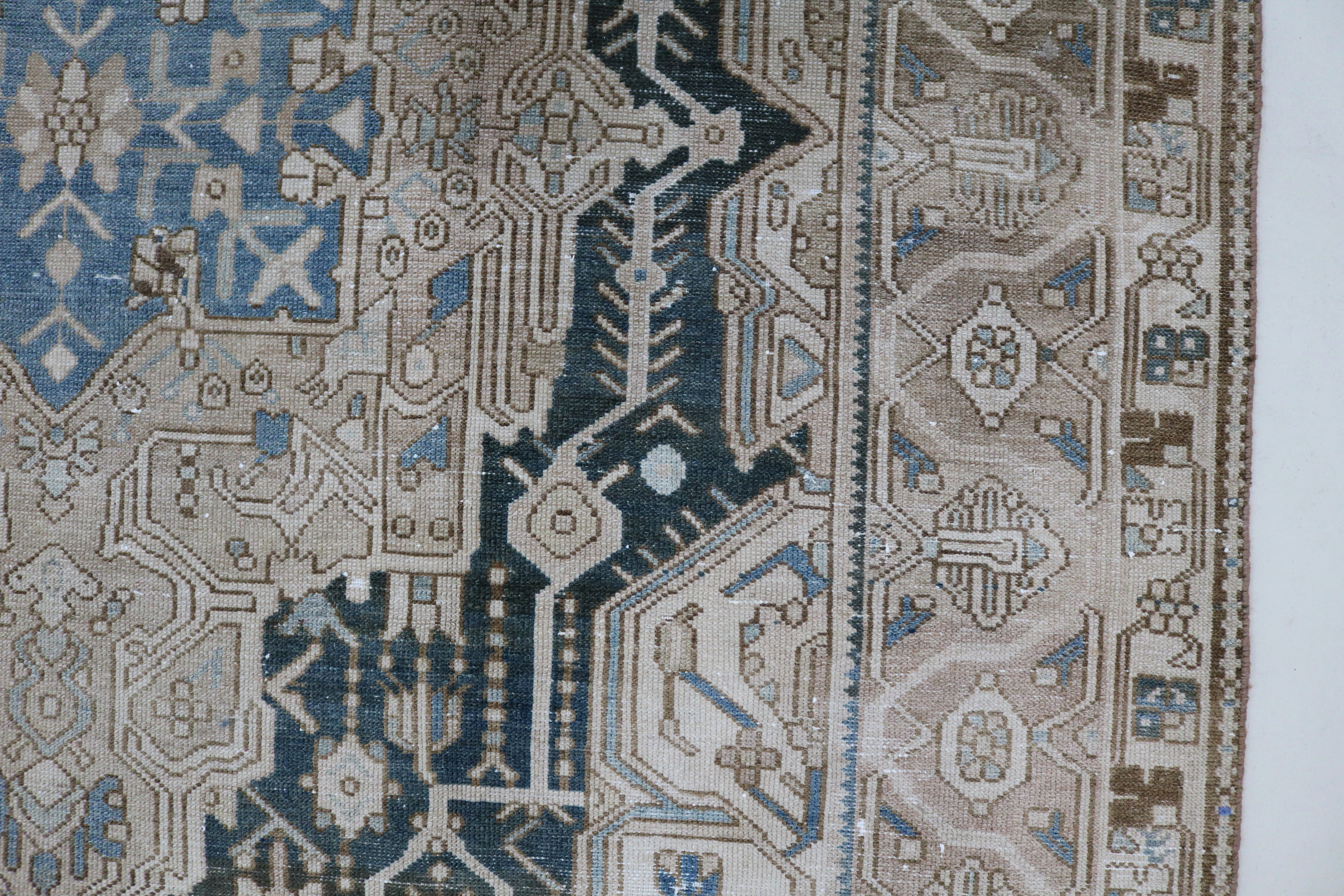 Close-up of hand-knotted wool texture on antique Persian Karaja carpet
