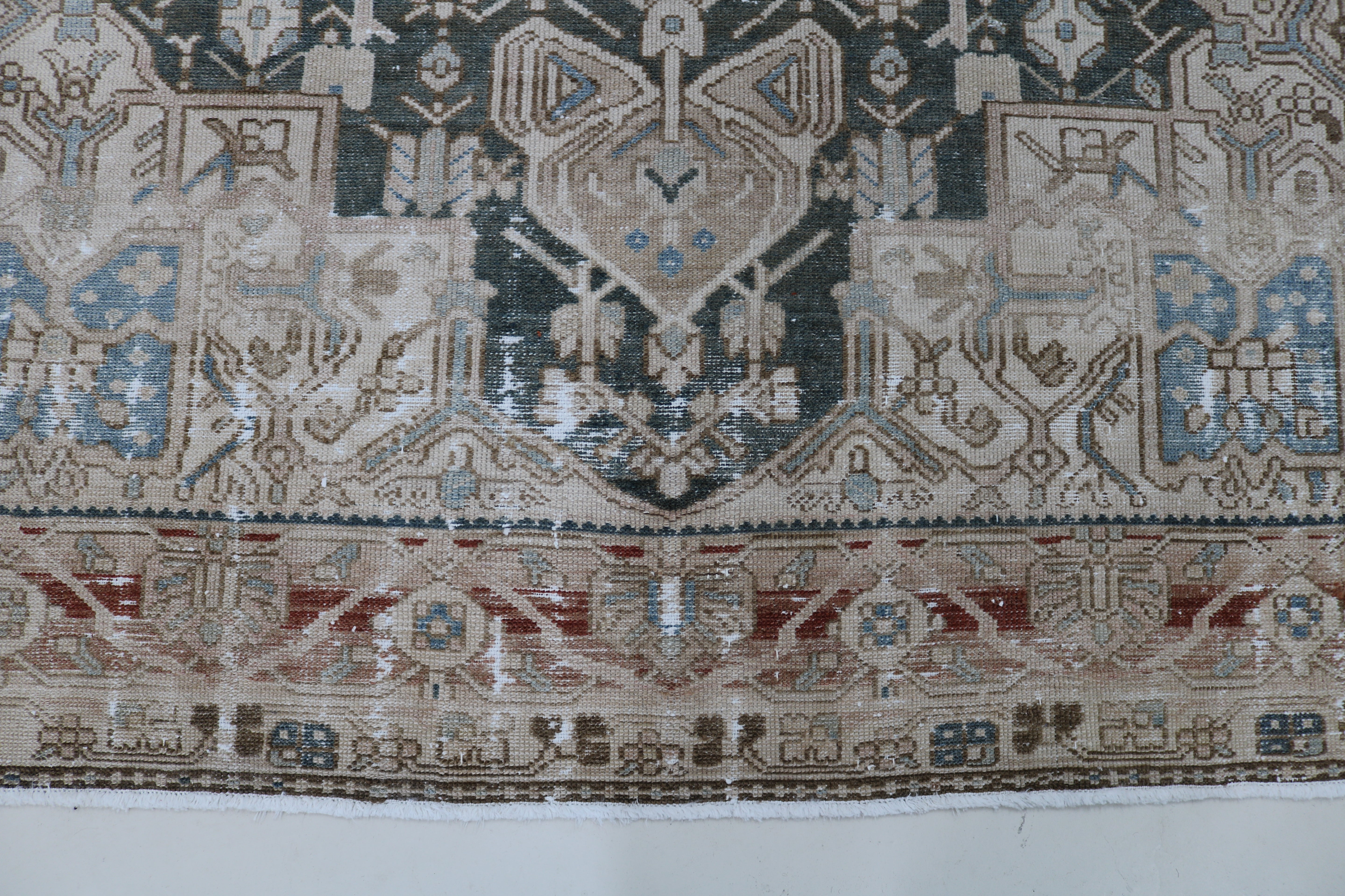 Close-up of hand-knotted wool texture on antique Persian Karaja carpet
