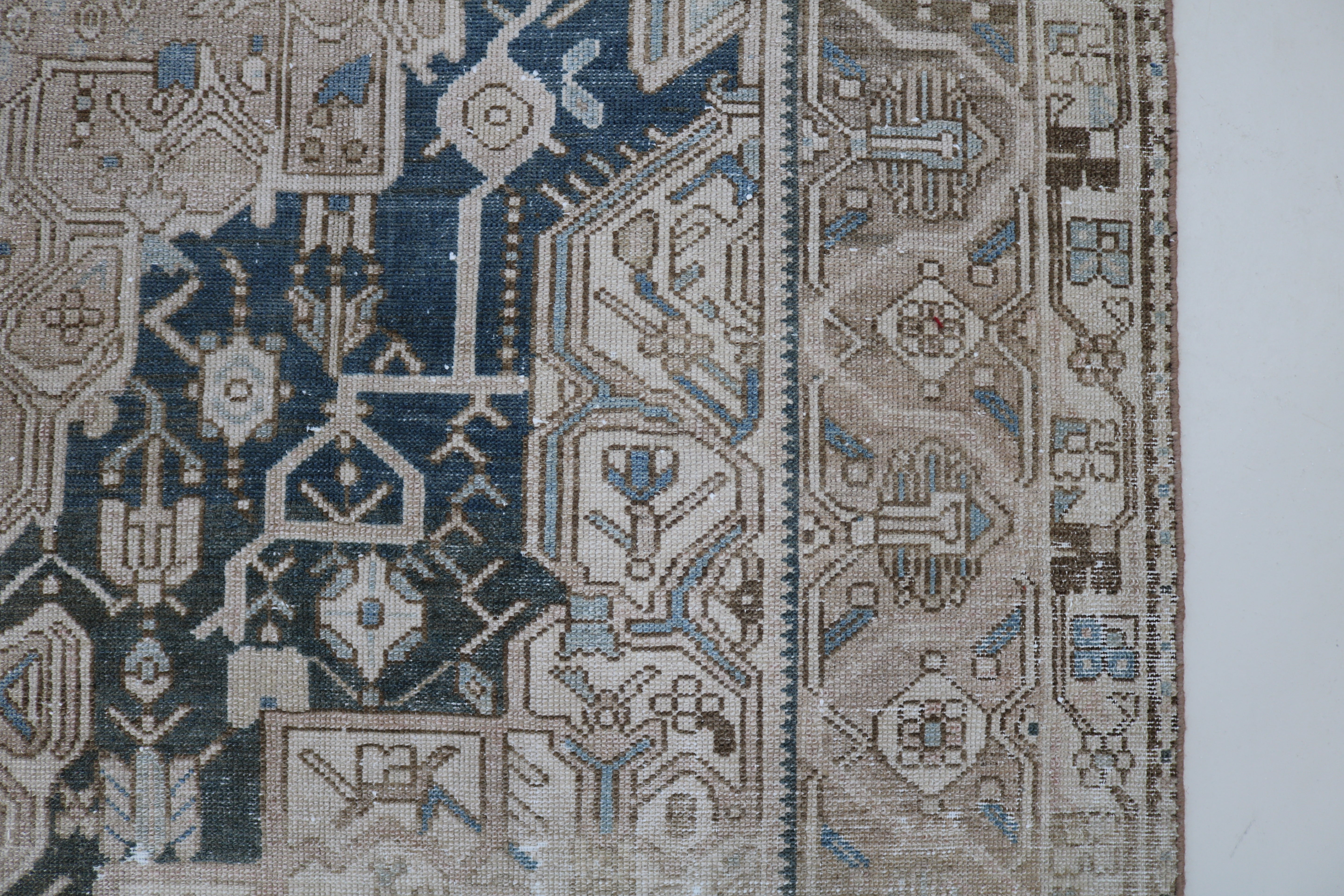Close-up of hand-knotted wool texture on antique Persian Karaja carpet
