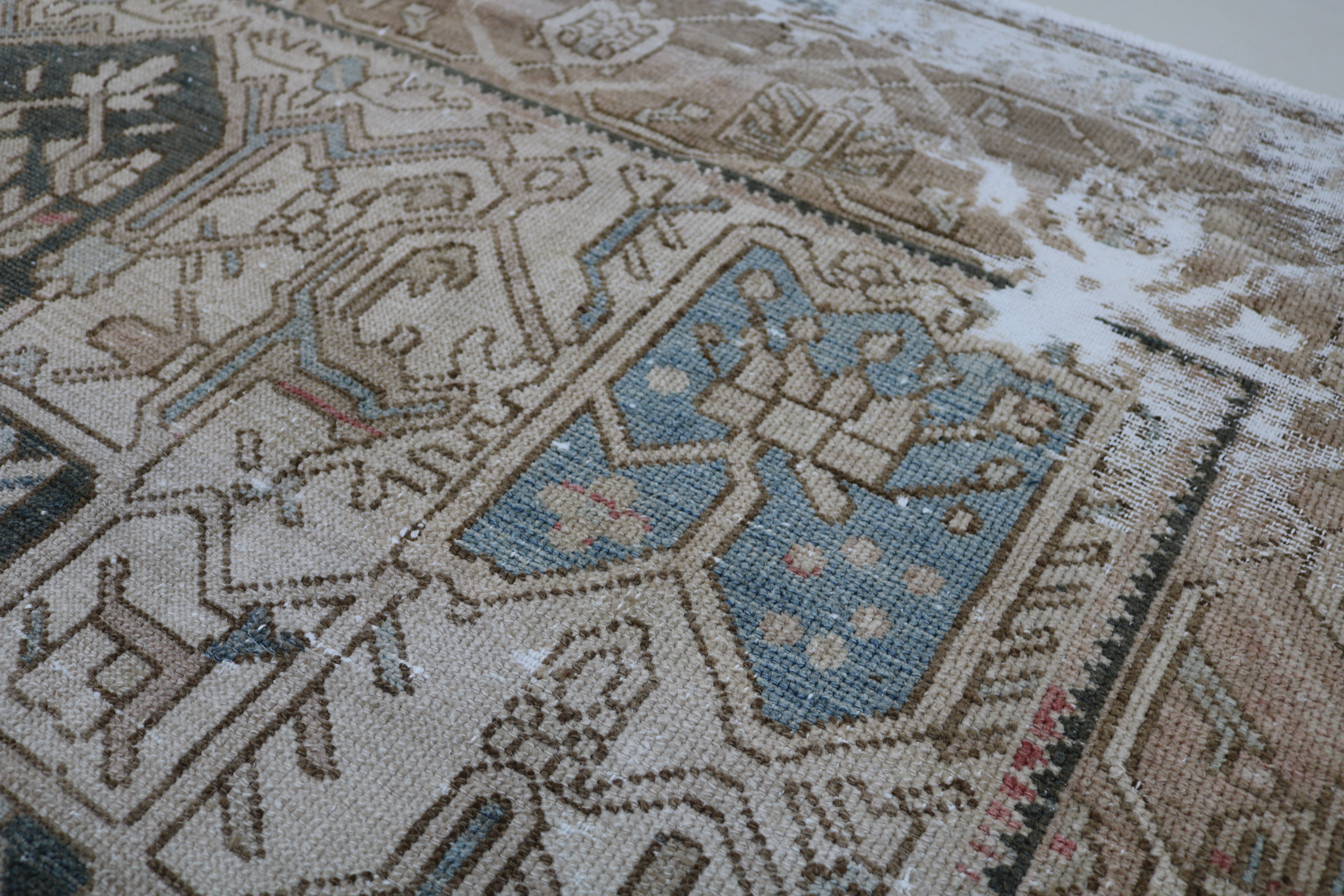 Close-up of hand-knotted wool texture on antique Persian Karaja carpet
