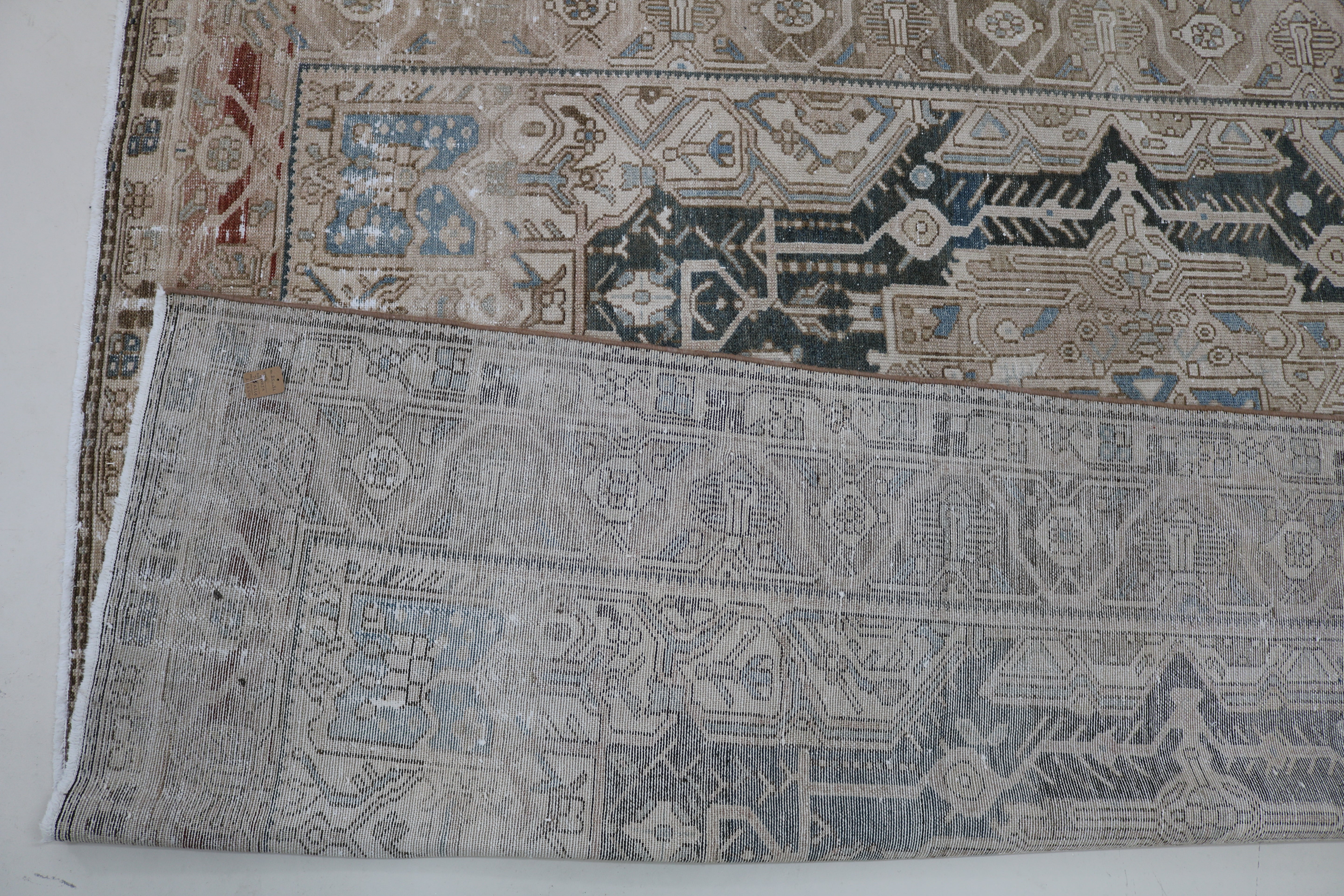 Close-up of hand-knotted wool texture on antique Persian Karaja carpet
