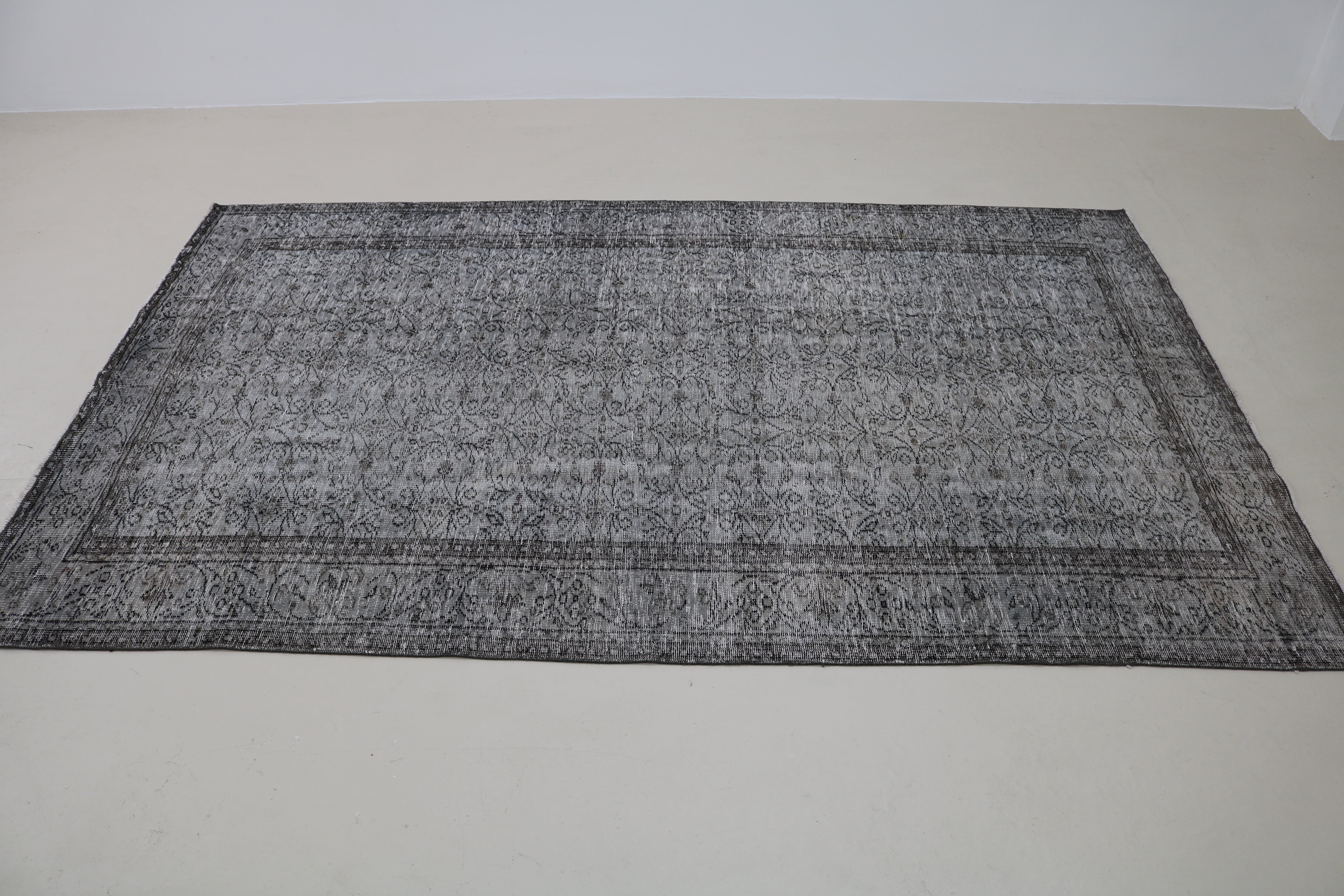 Perspective view of vintage Turkish Sparta rug on floor
