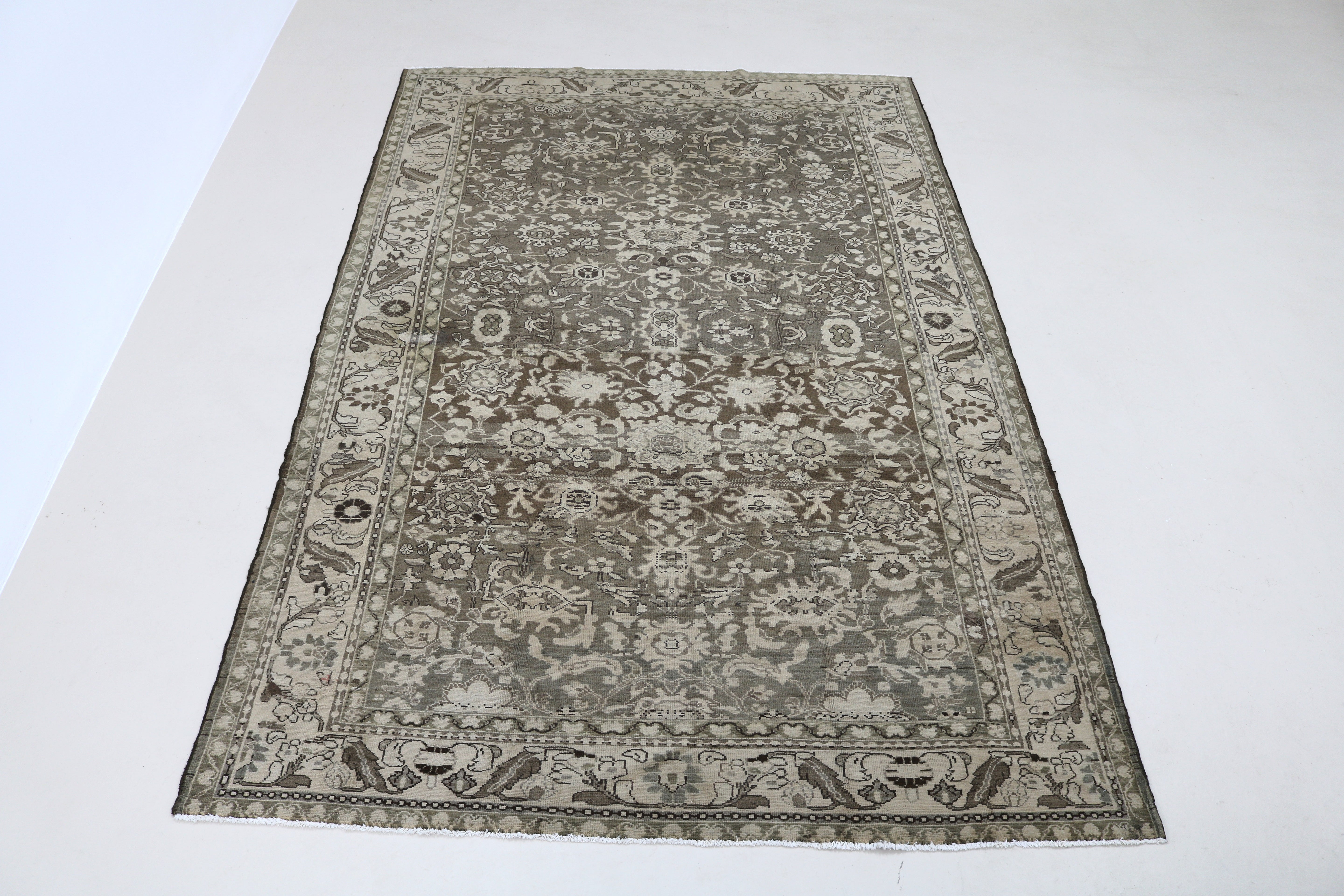 Full view of Persian Malayer carpet with delicate floral motifs and muted colour palette
