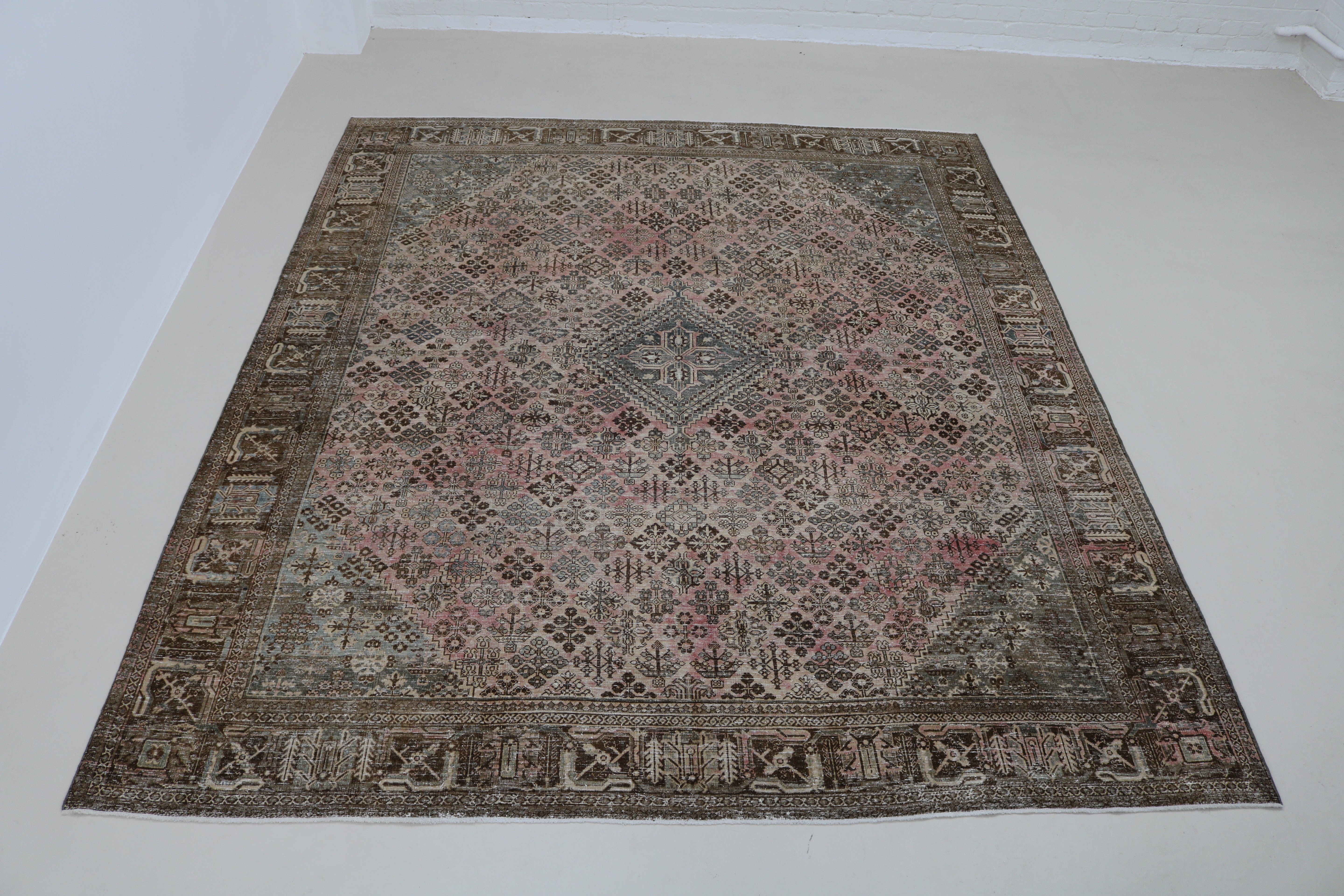 Full view of Persian Josheqan carpet with classic lattice and floral panel design
