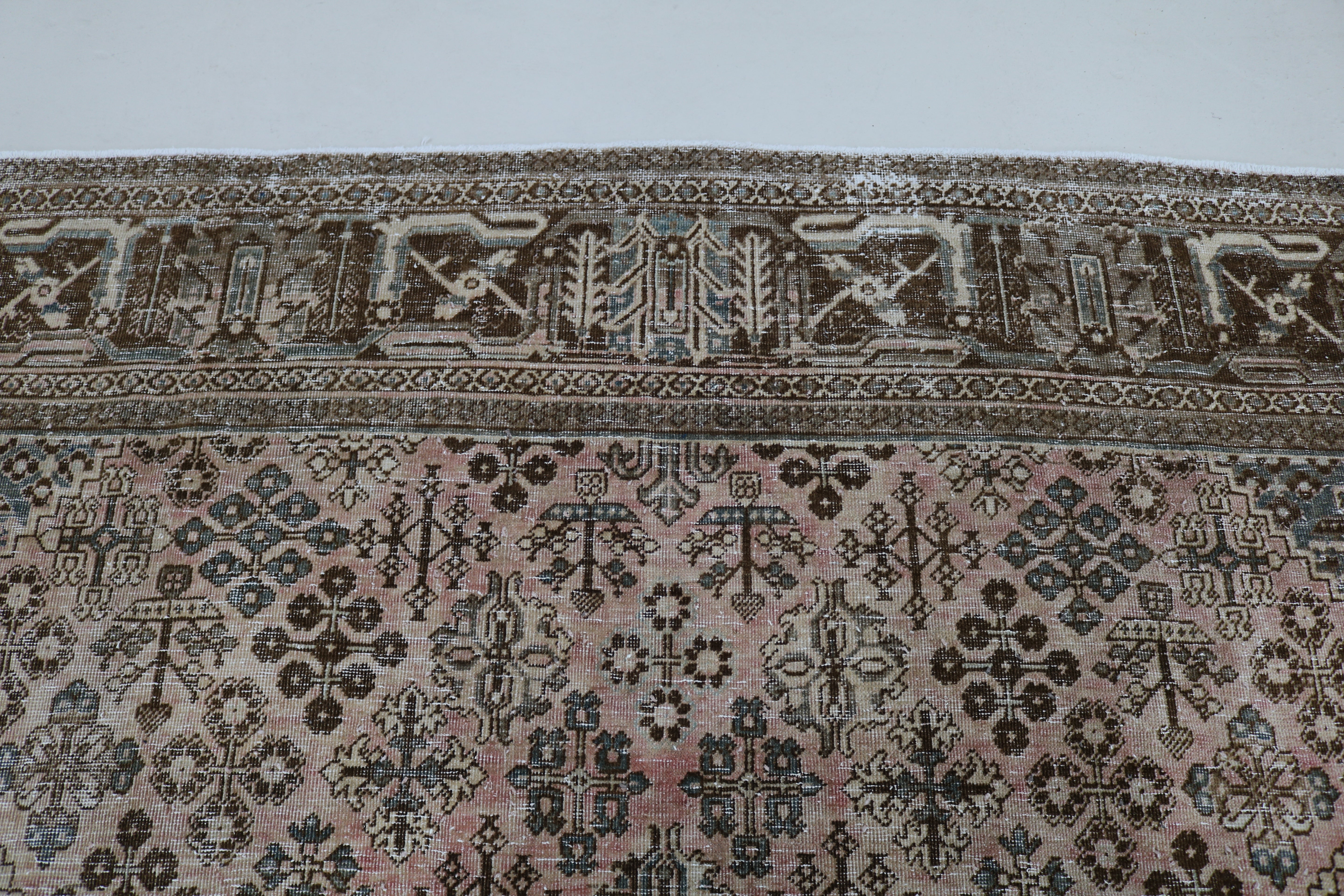Close-up of hand-knotted wool texture on Persian Josheqan carpet
