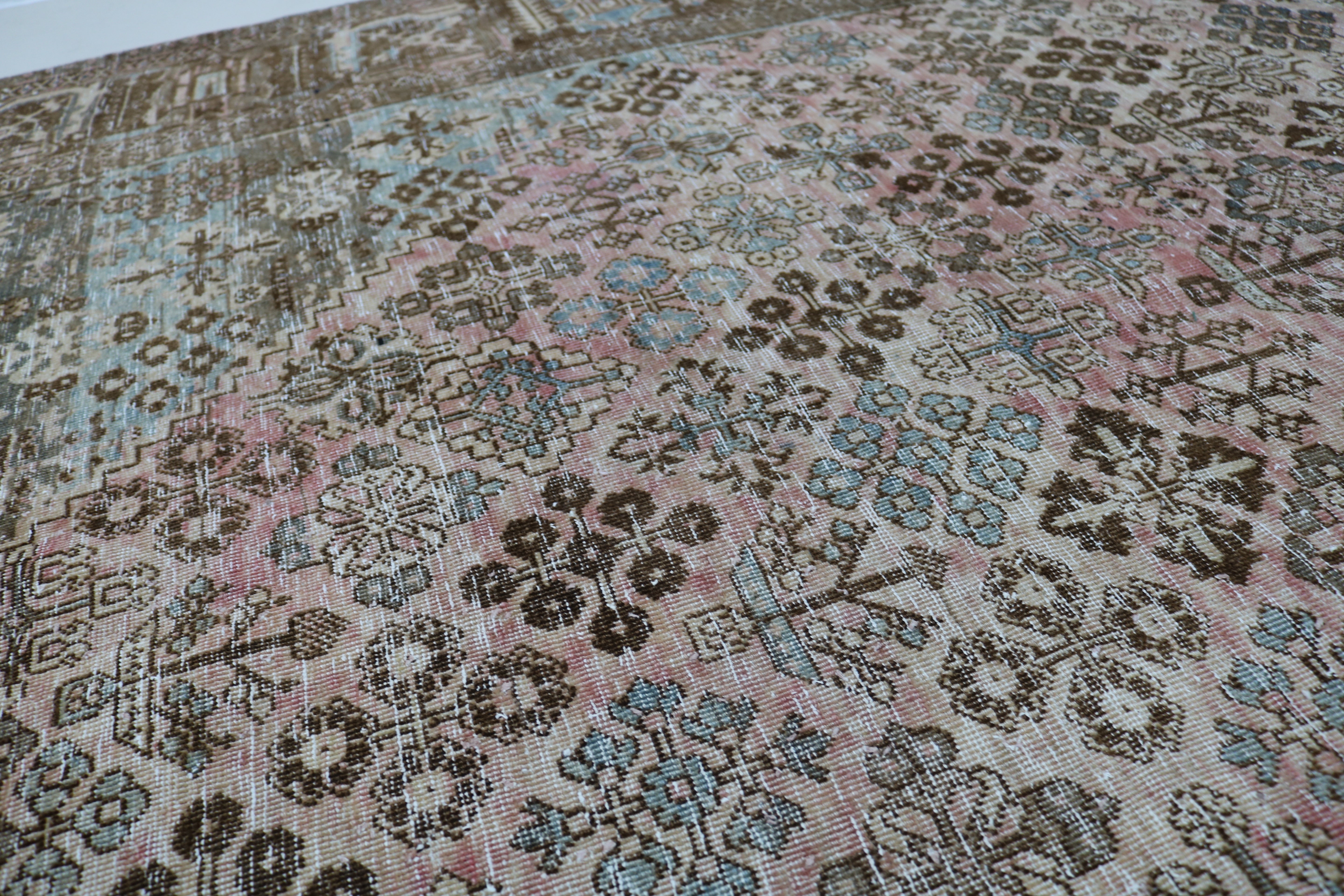 Close-up of hand-knotted wool texture on Persian Josheqan carpet
