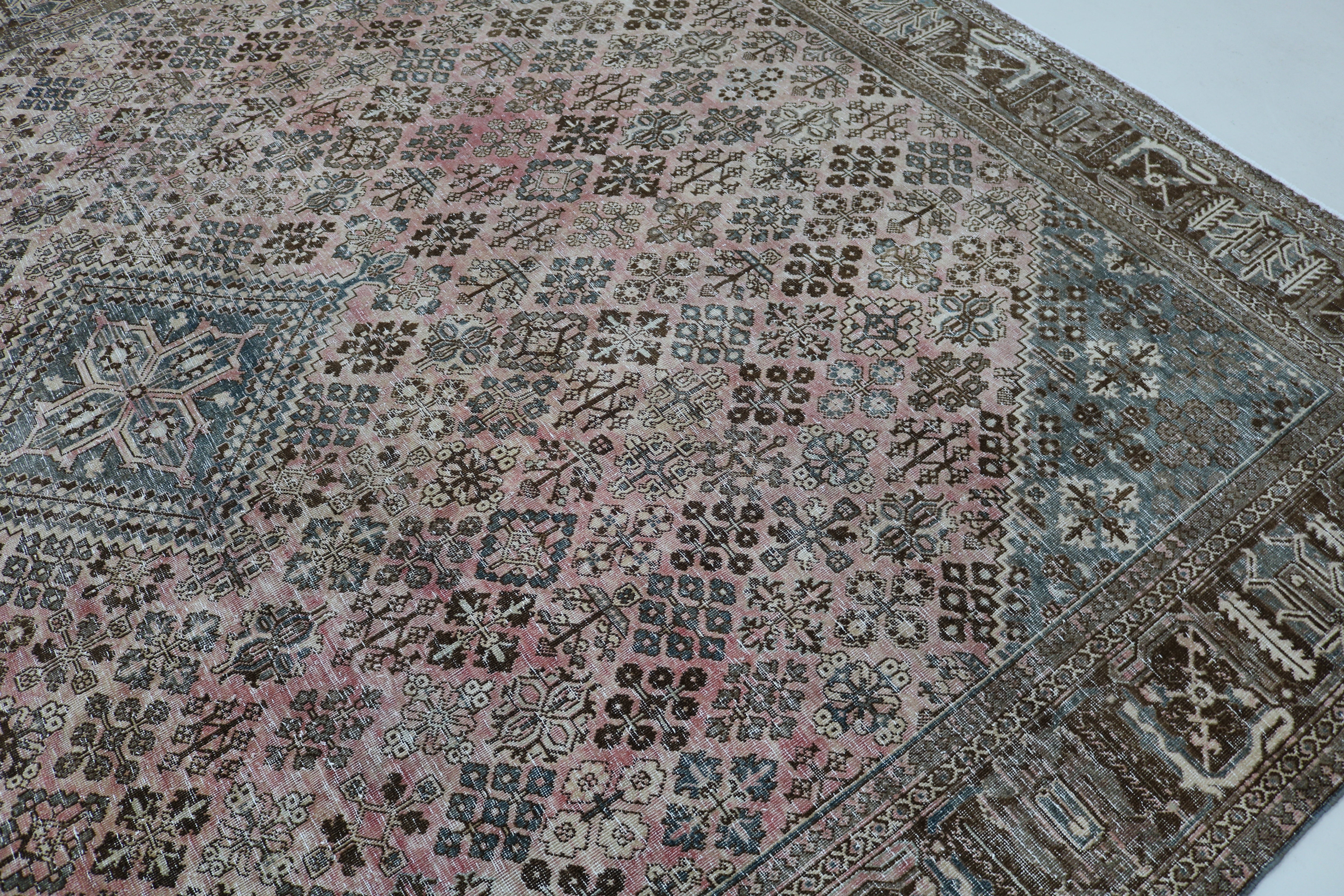 Close-up of hand-knotted wool texture on Persian Josheqan carpet
