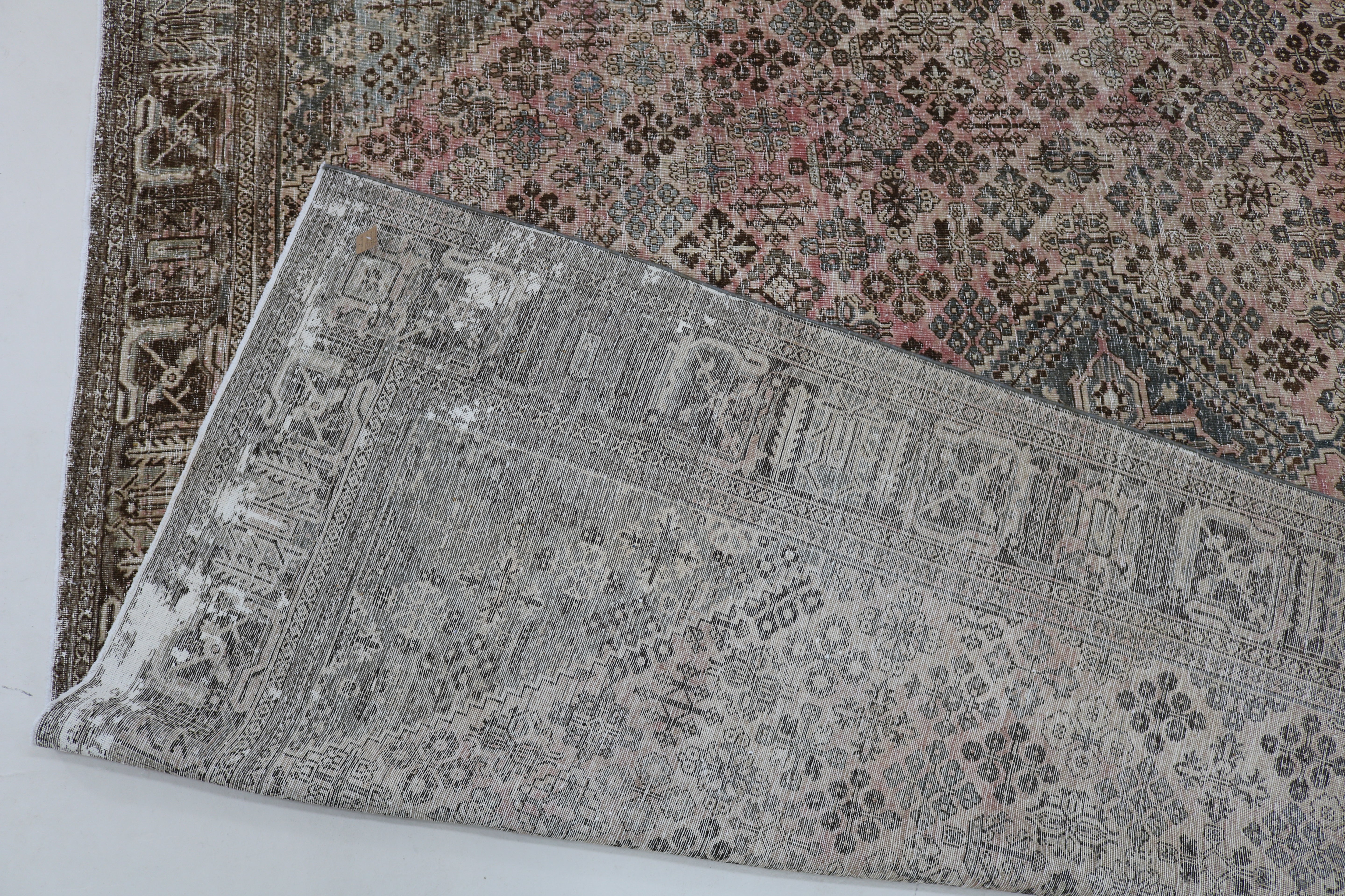 Close-up of hand-knotted wool texture on Persian Josheqan carpet
