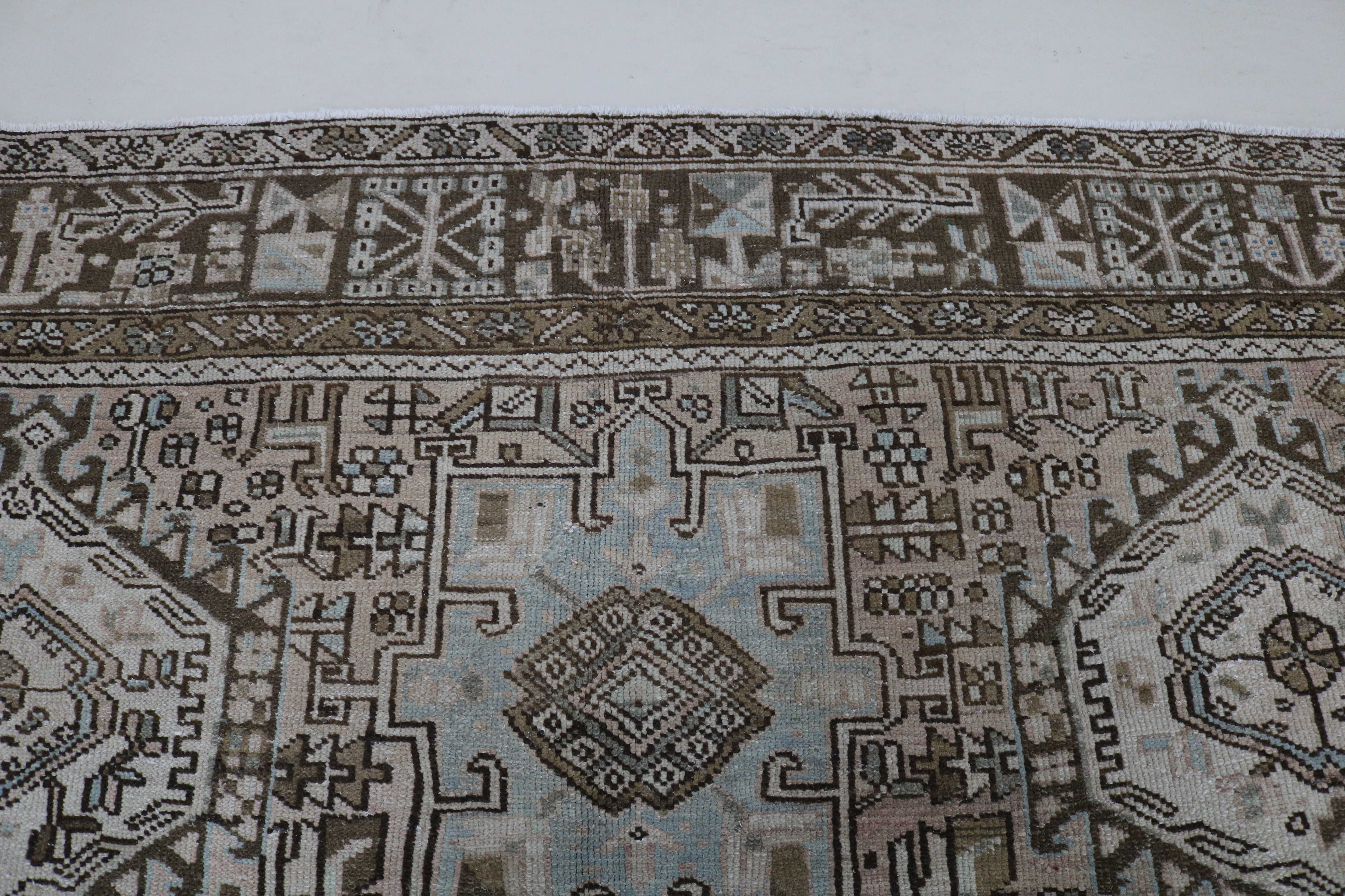 Close-up of hand-knotted wool texture on antique Persian Heriz–Karaja carpet
