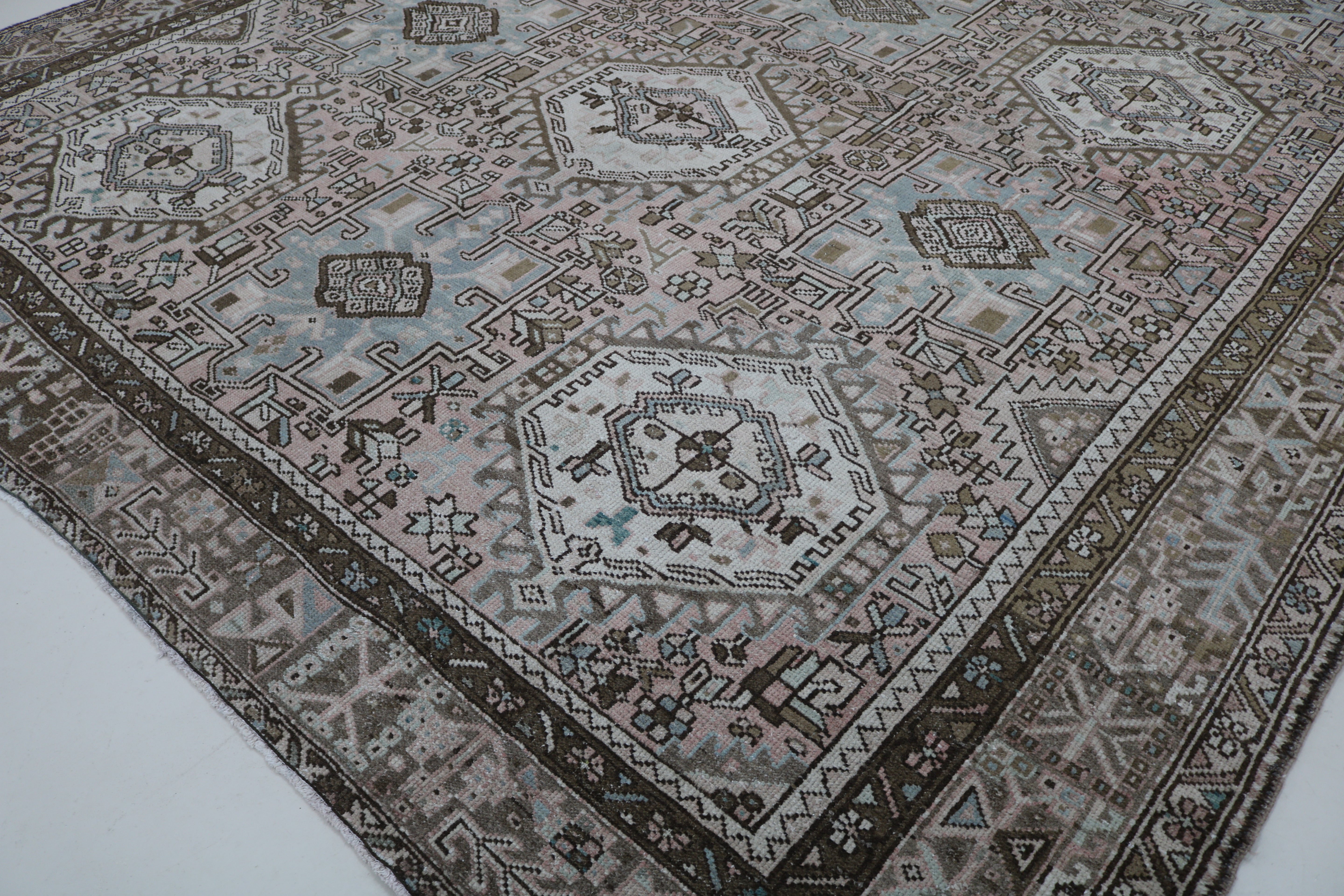 Close-up of hand-knotted wool texture on antique Persian Heriz–Karaja carpet
