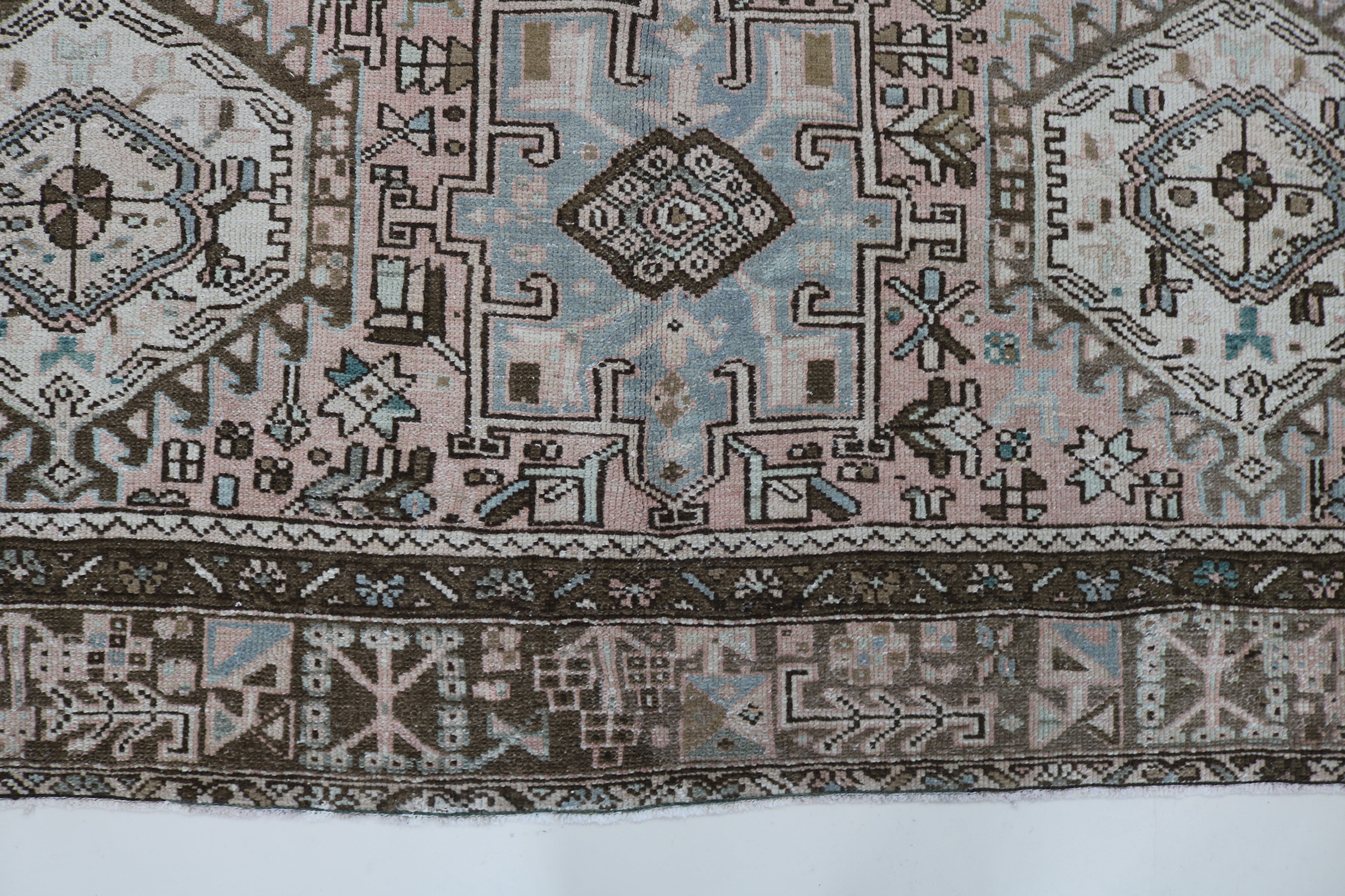 Close-up of hand-knotted wool texture on antique Persian Heriz–Karaja carpet
