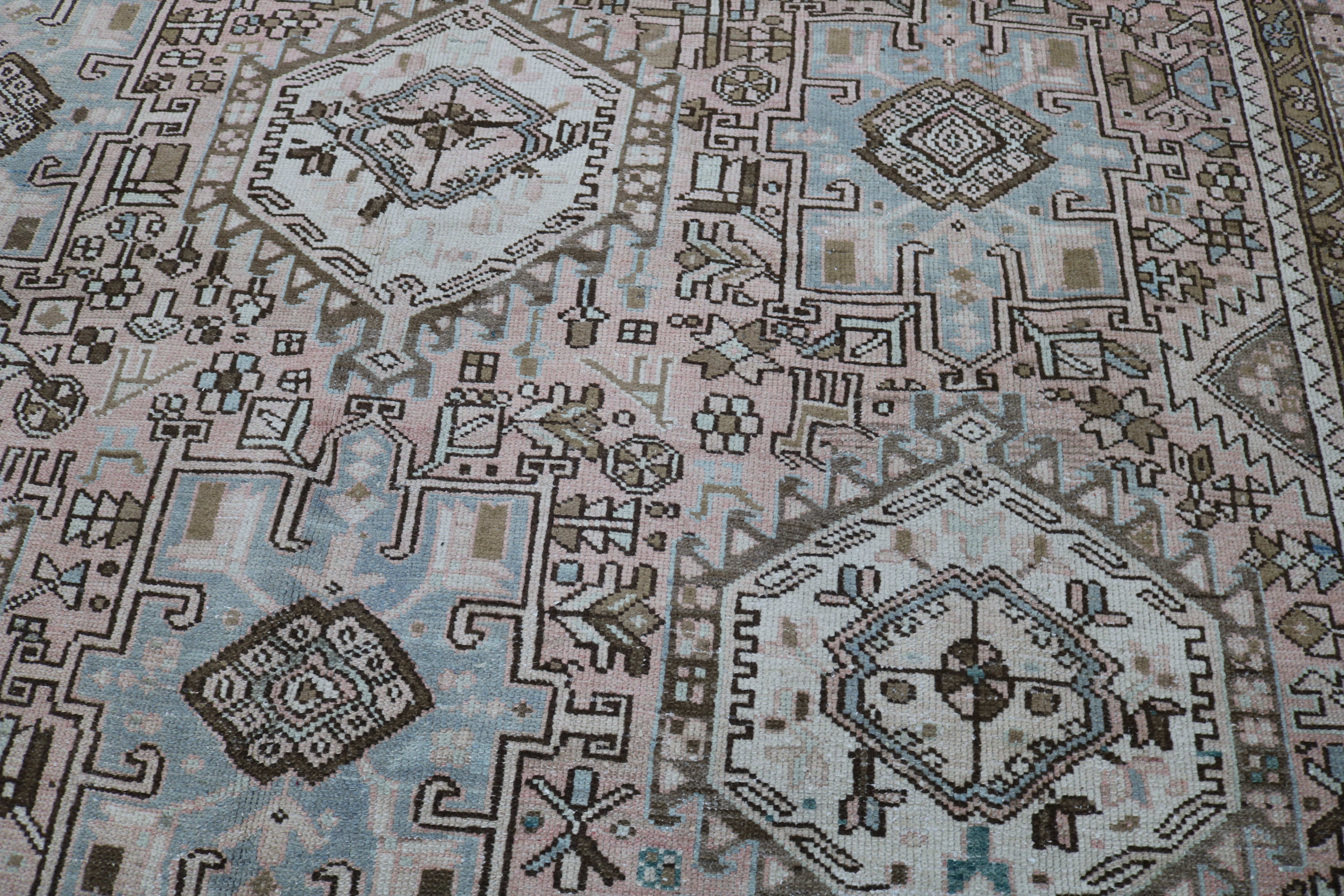 Close-up of hand-knotted wool texture on antique Persian Heriz–Karaja carpet
