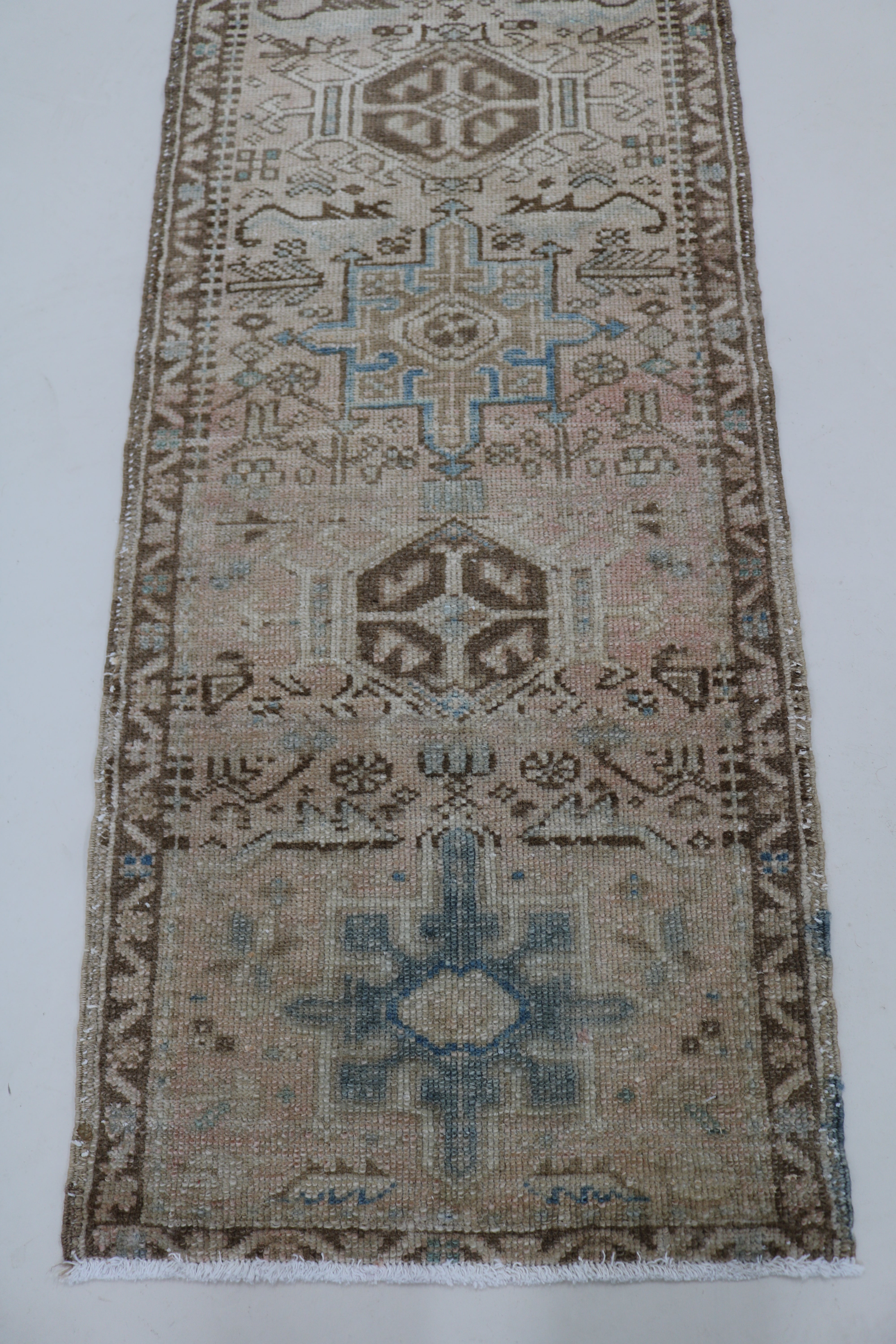 Perspective view of antique Persian Heriz runner on floor

