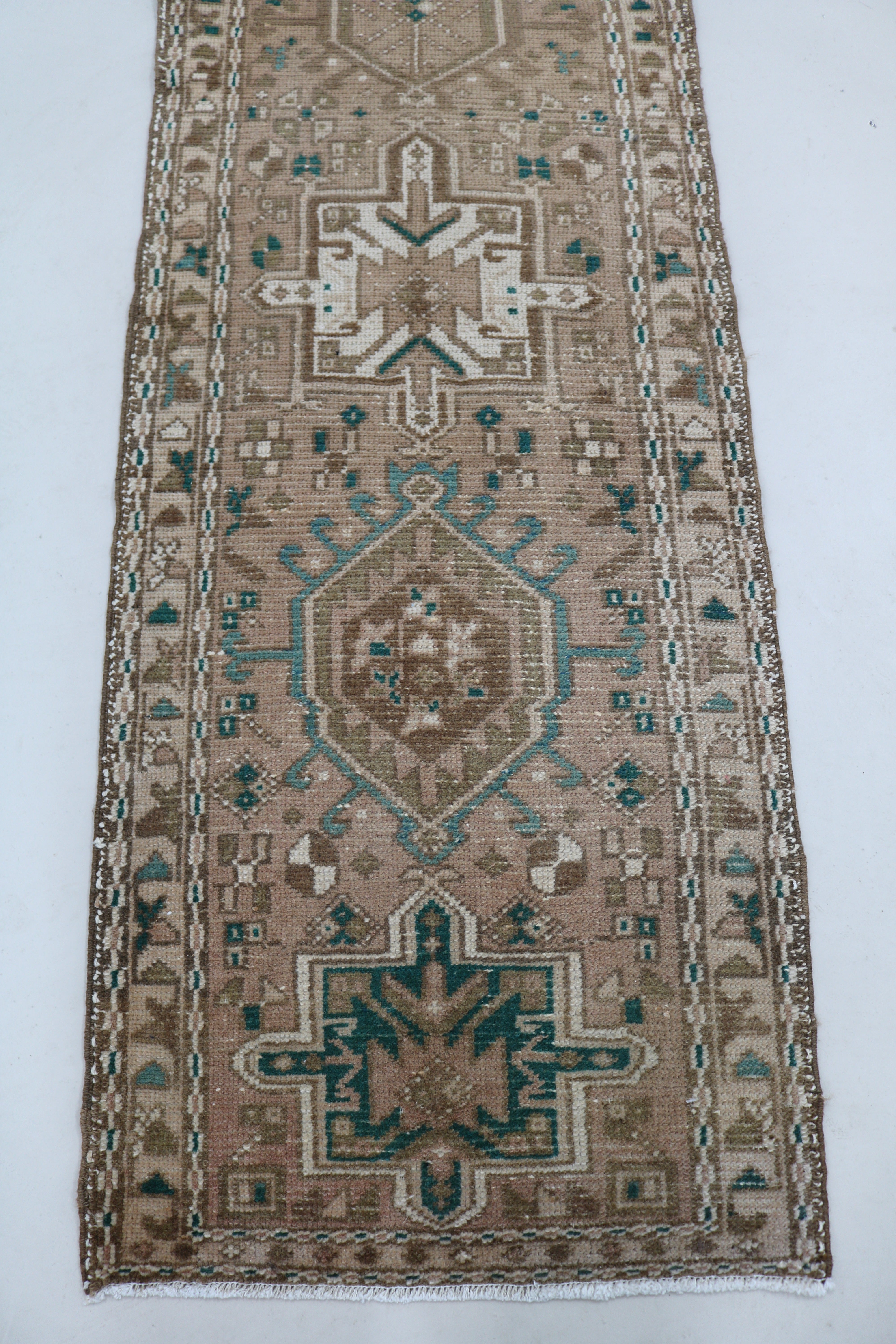 Close-up of hand-knotted wool texture on antique Persian Heriz runner
