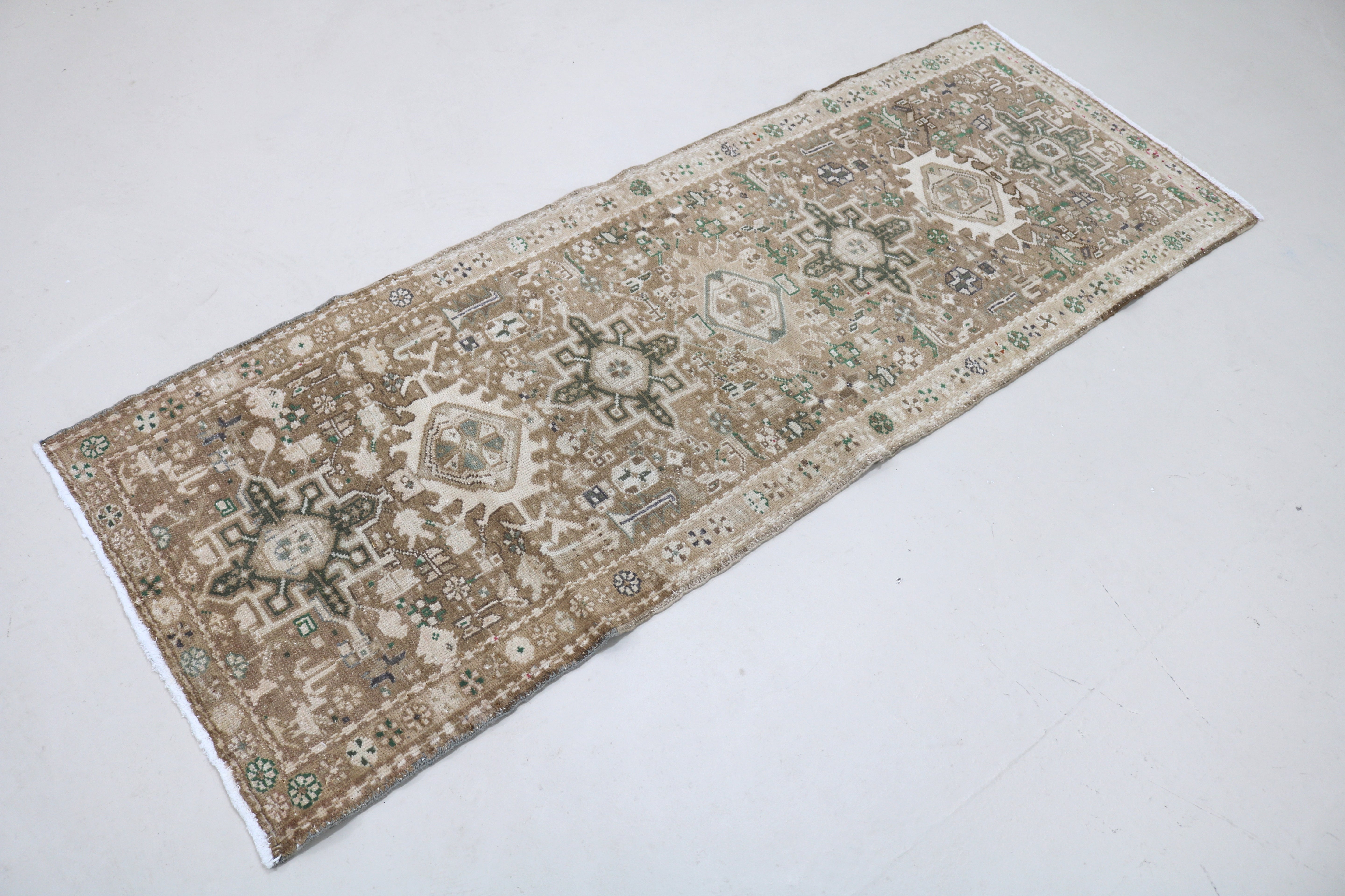 Angled view of antique Persian Heriz runner showing field and borders
