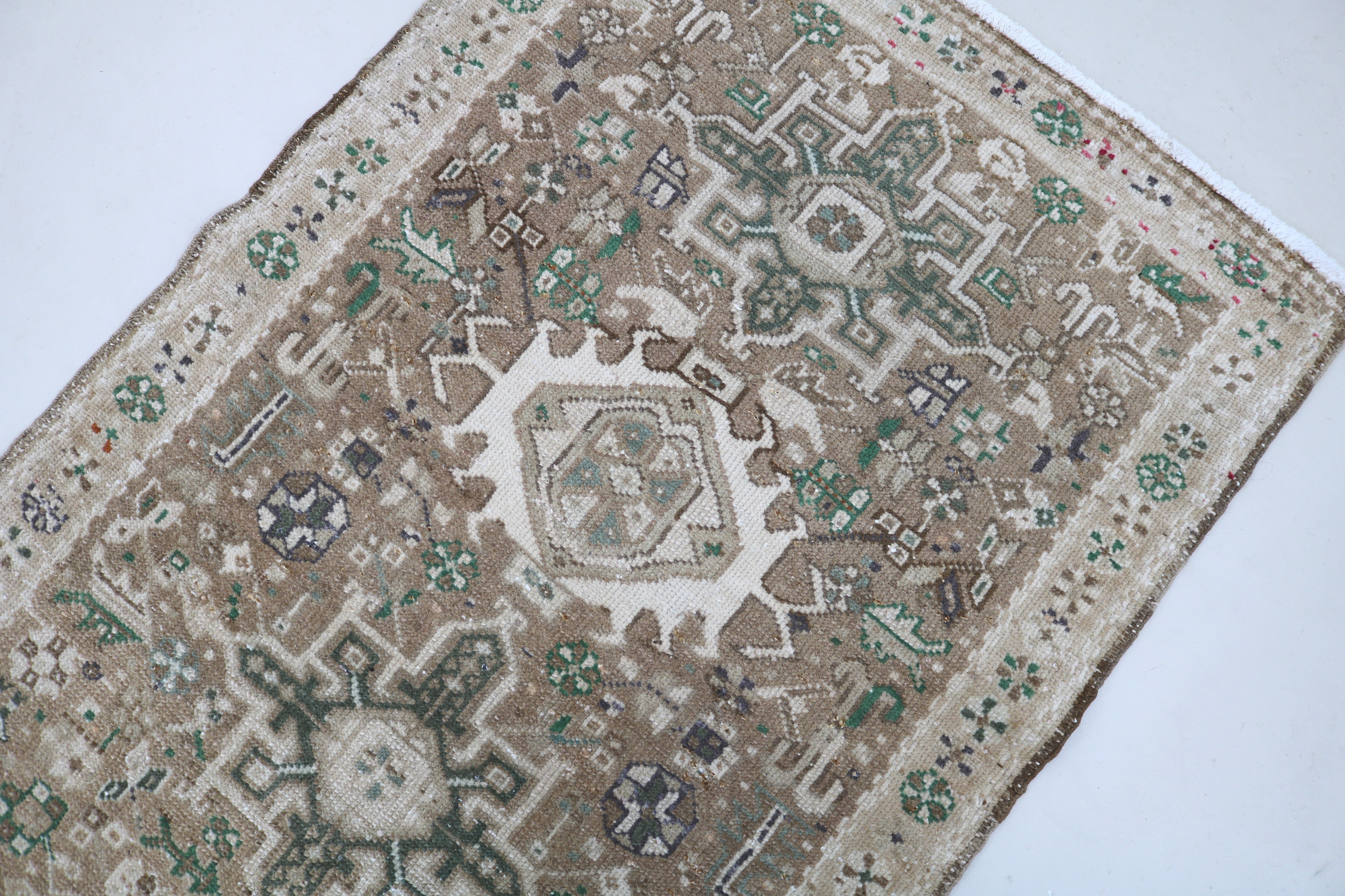 Perspective view of antique Persian Heriz runner on floor
